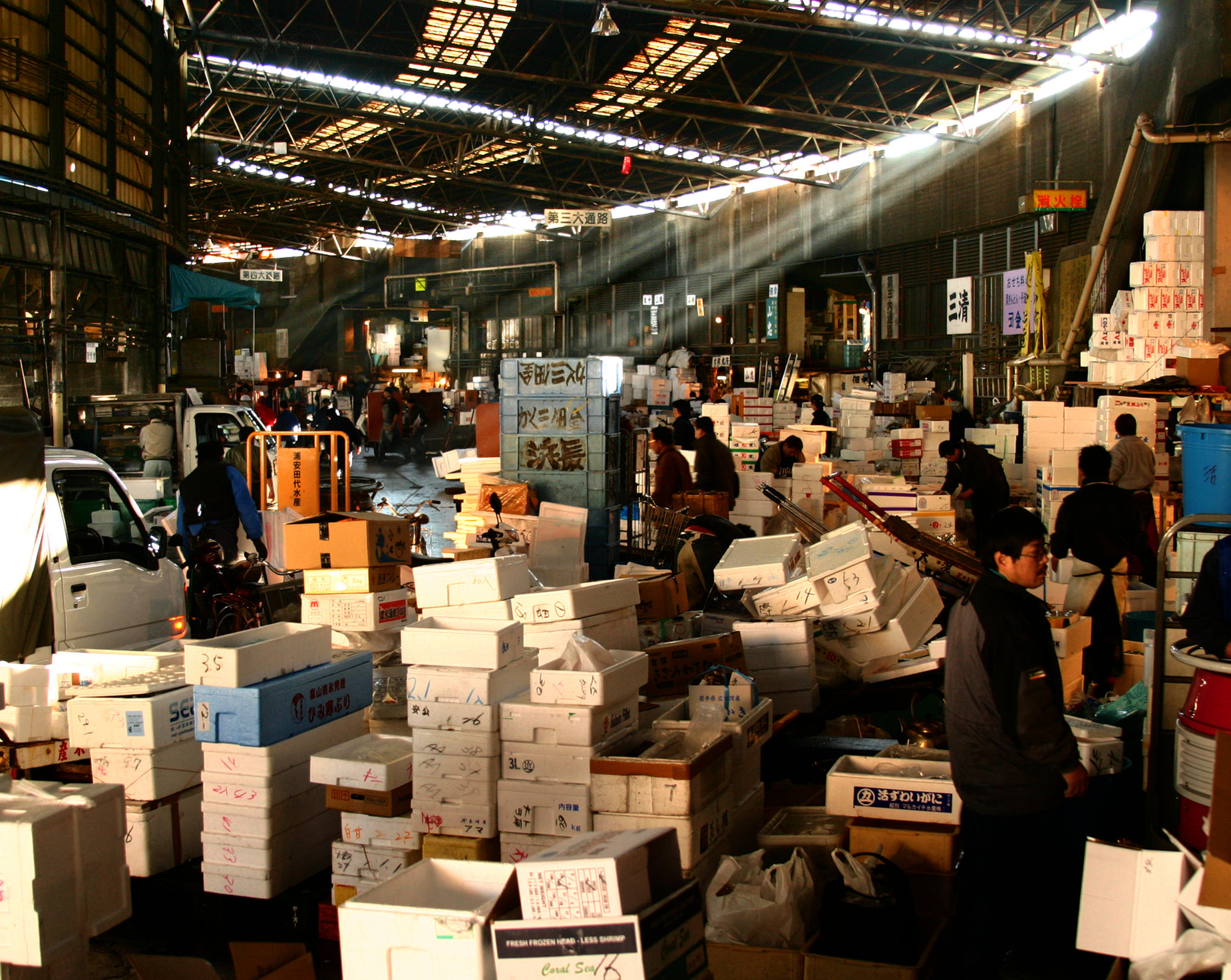 a warehouse is packed with boxes, a fork and several people