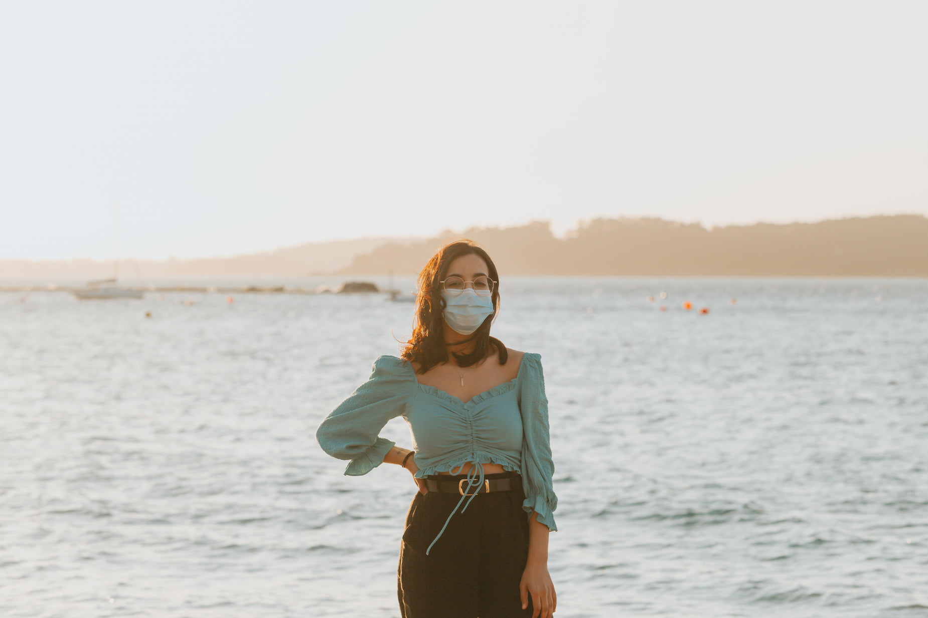 woman wearing face mask on body of water