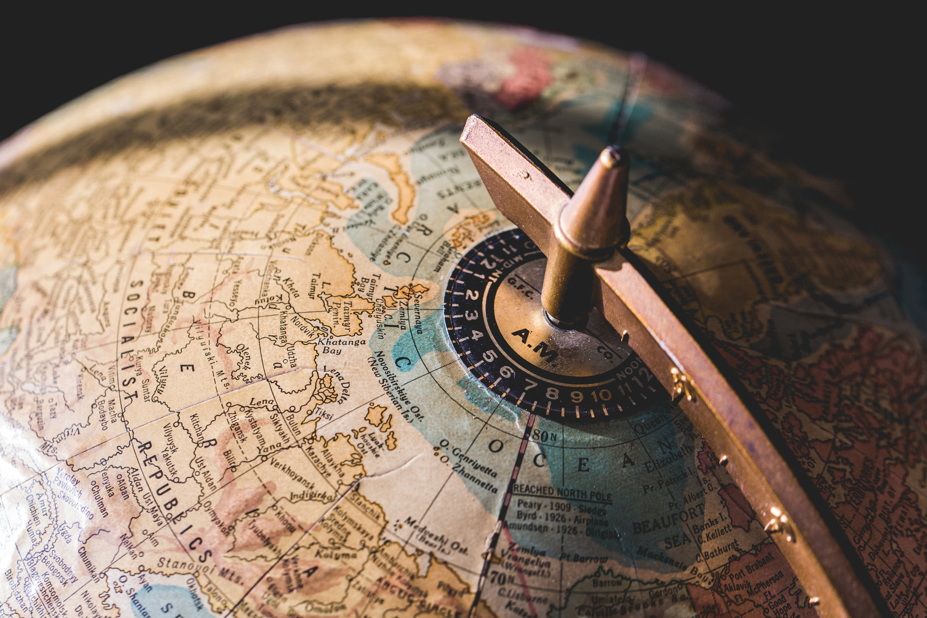 an old compass sits on top of a world globe