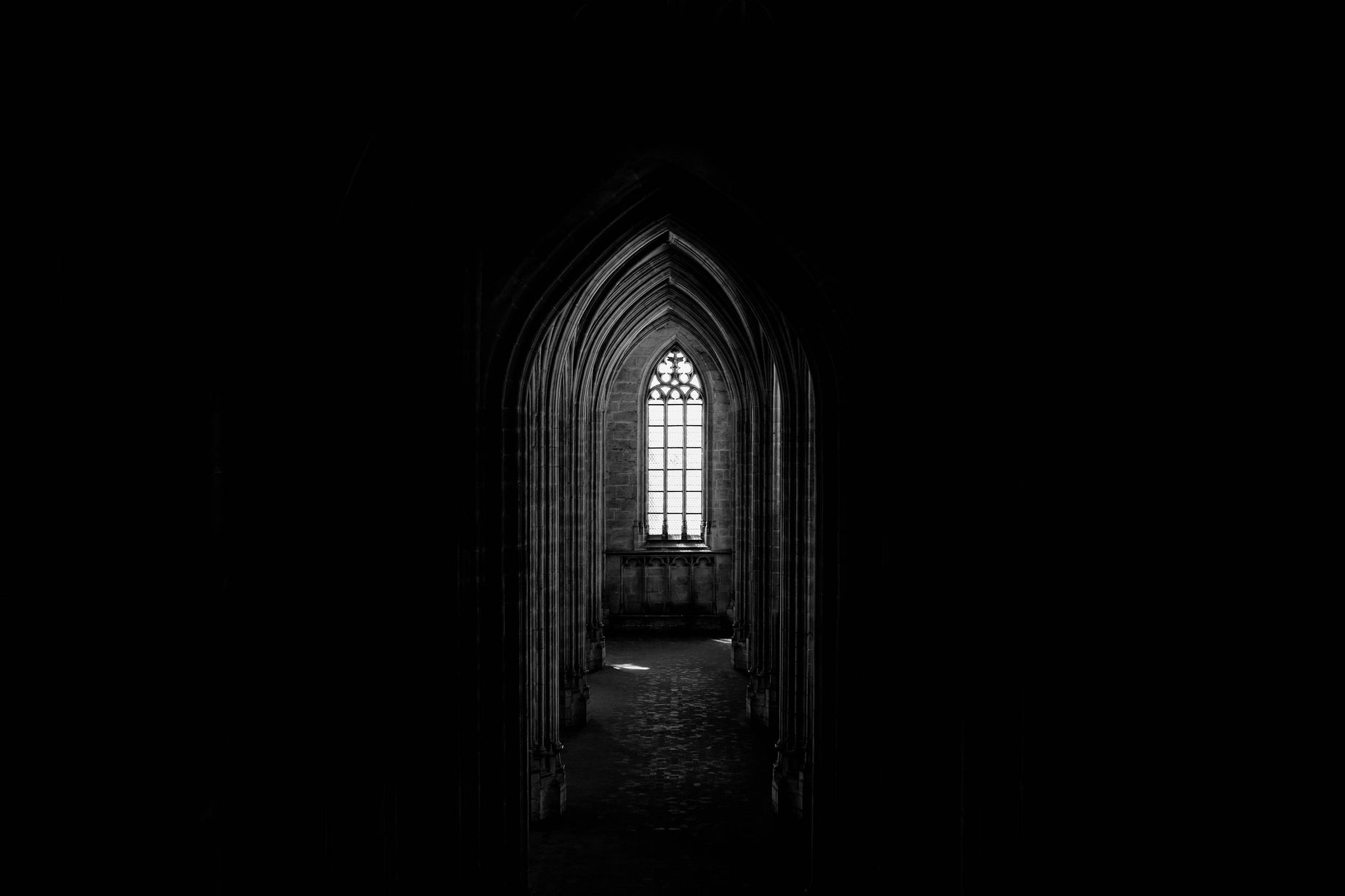 an empty chapel with a large window inside