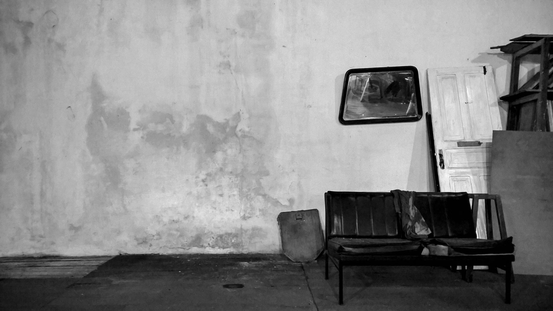 two chairs and a lamp are by the wall