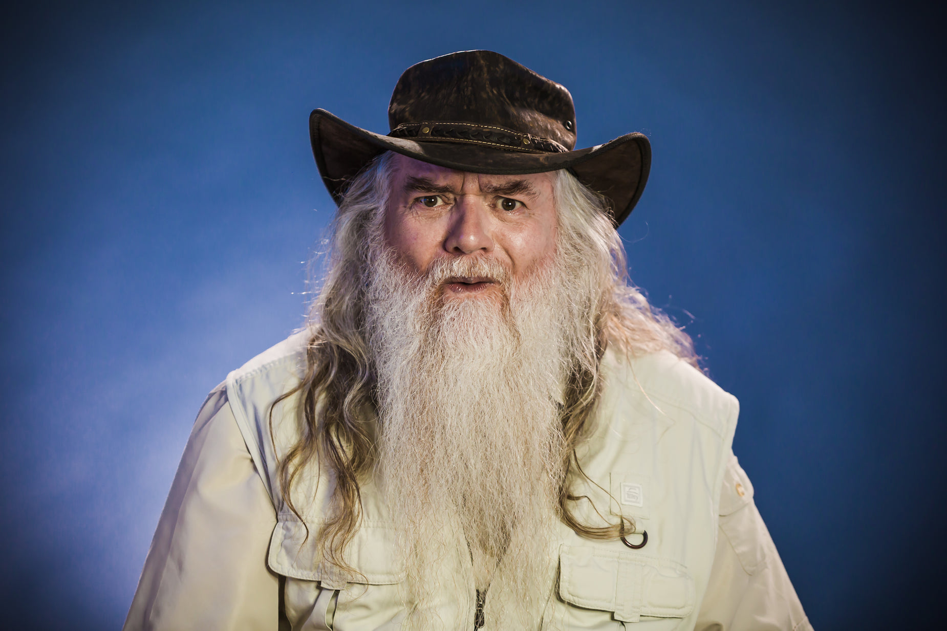 a long haired, bearded man with long, gray hair and hat