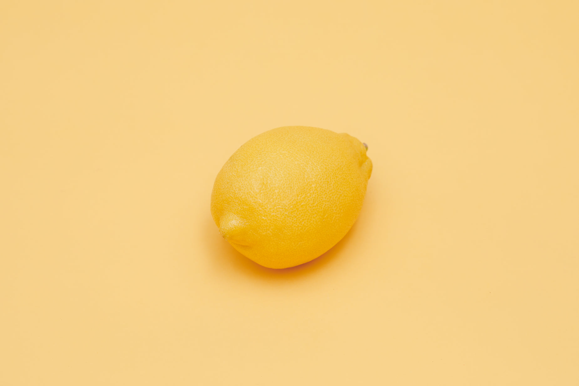 a lemon on a yellow background looking up