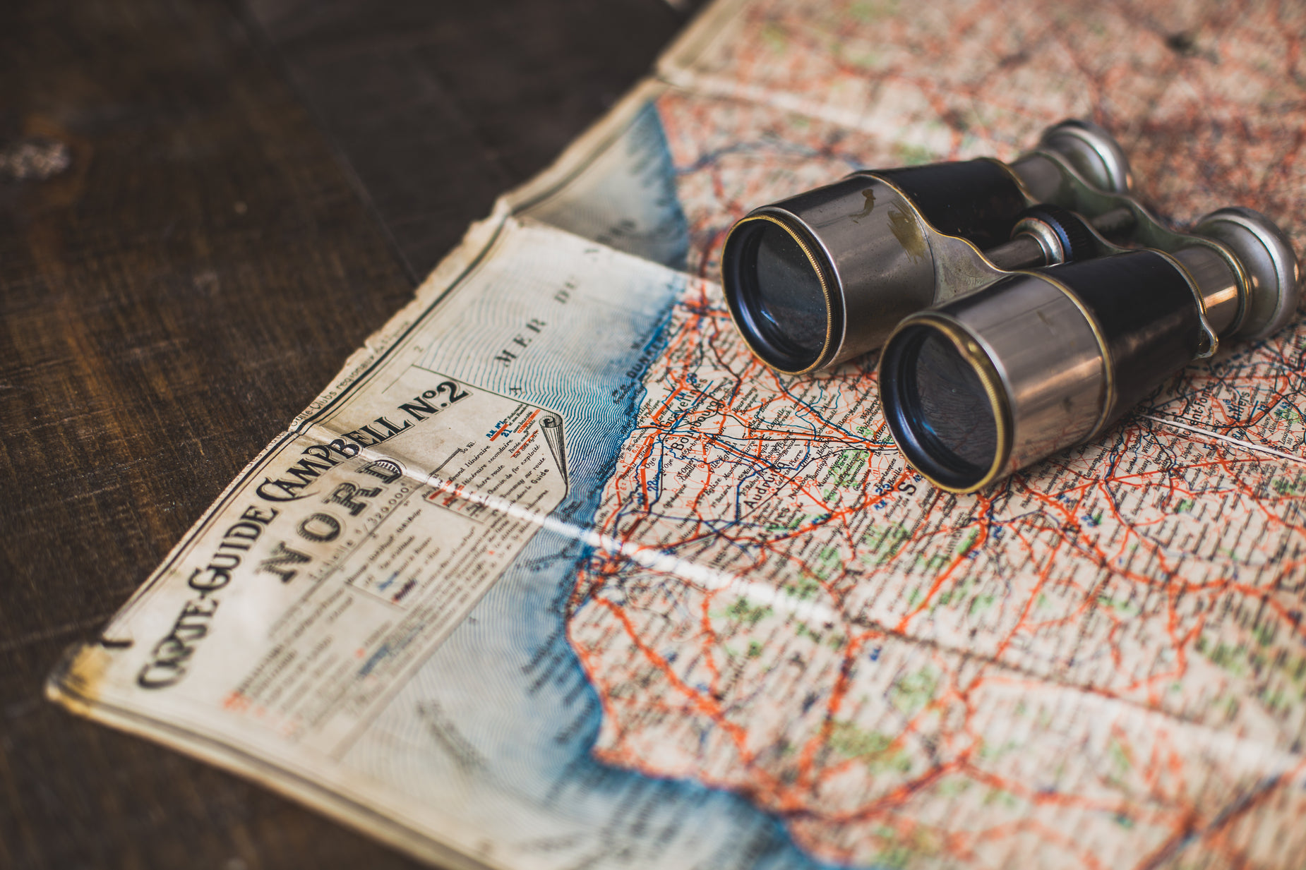 three binoculars sitting on a map that shows the location of moscow