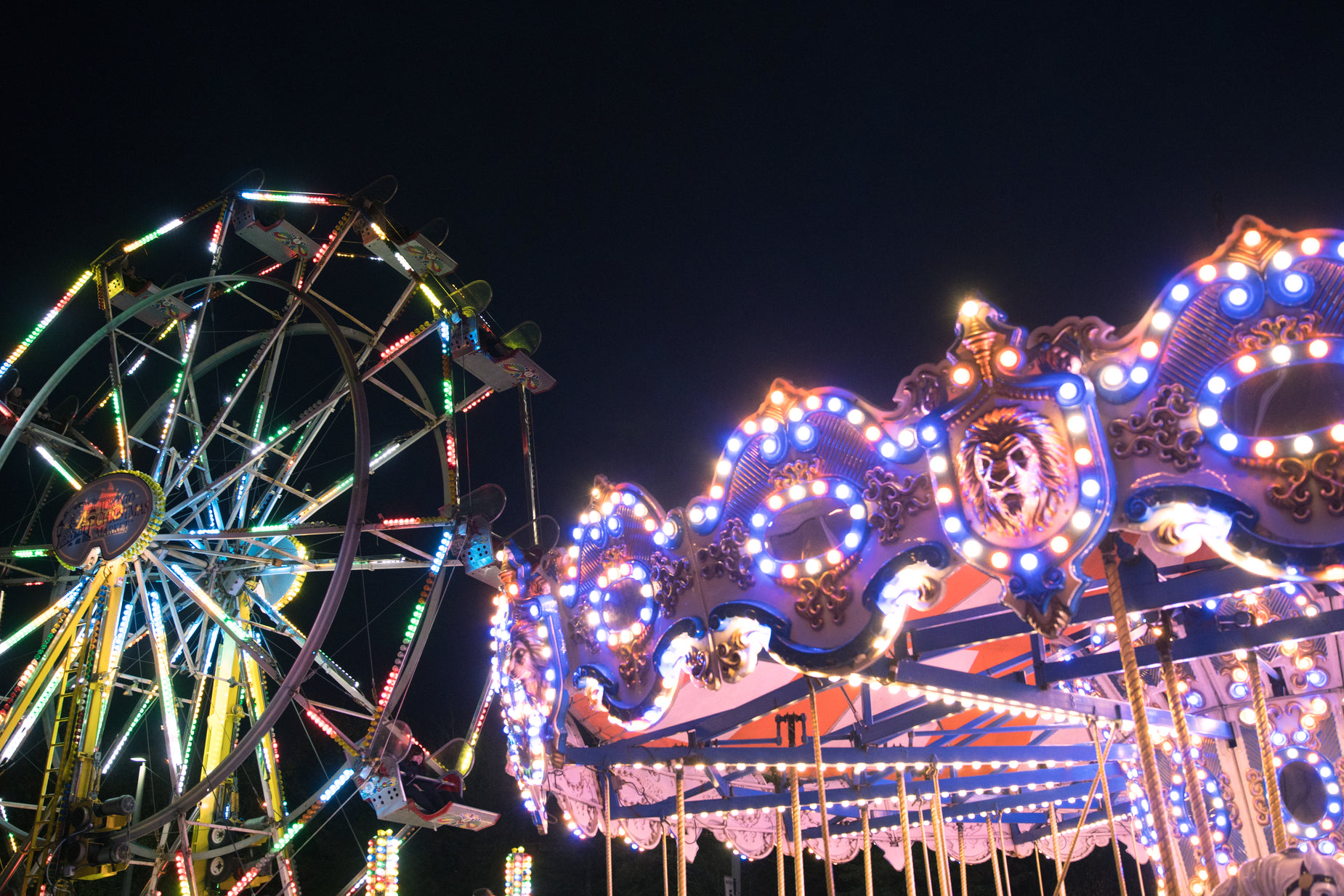 a carnival ride with lights lit up all around