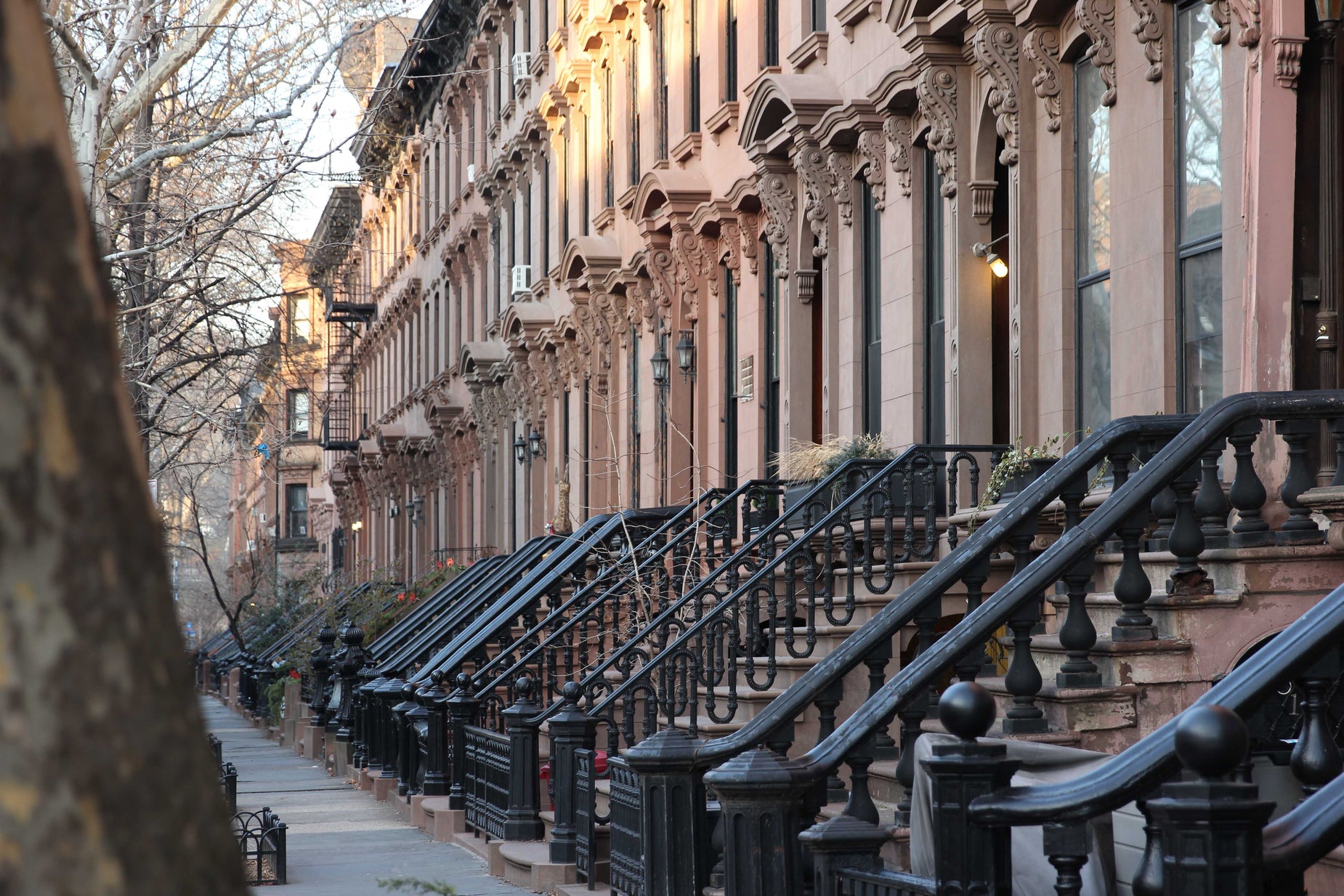 row houses lined with wrought iron railings in the city
