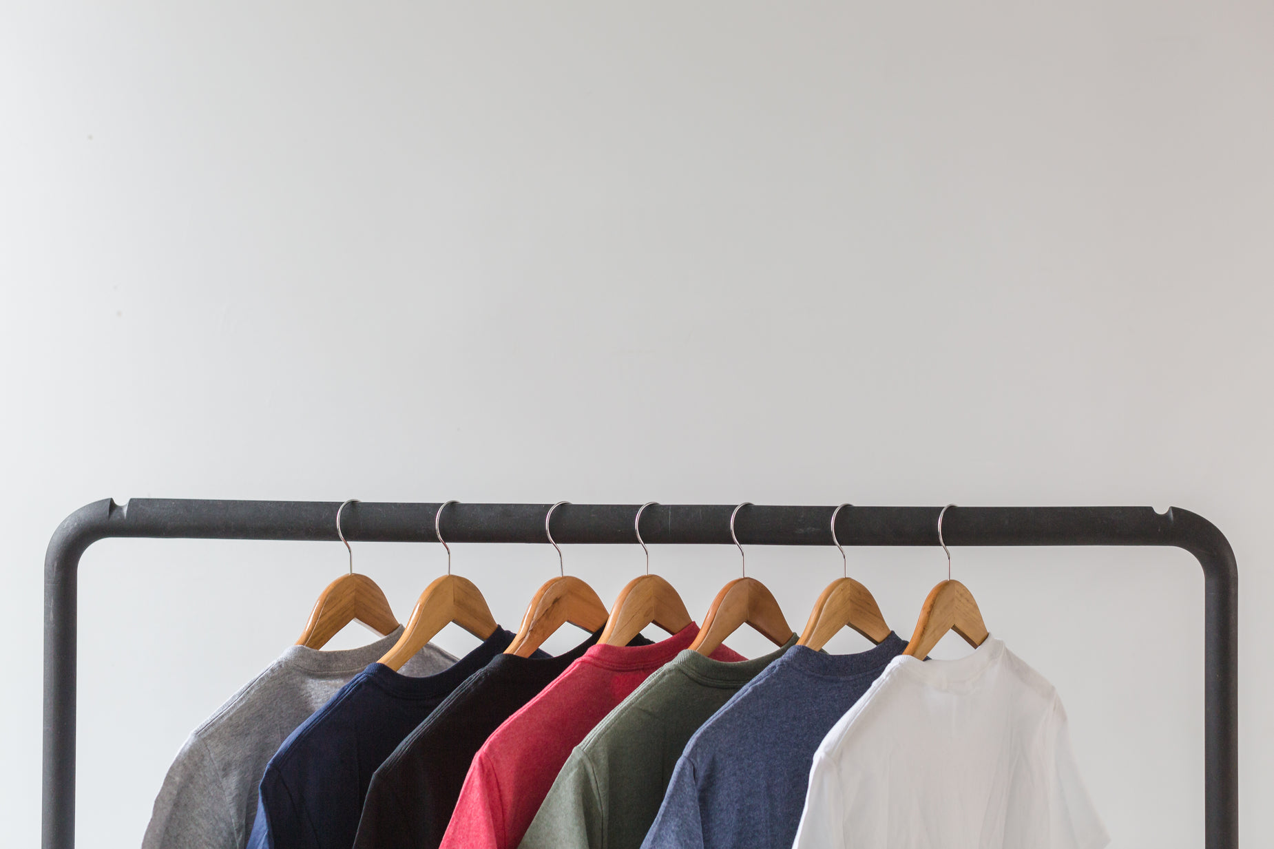 a row of clothes hangs from a rack