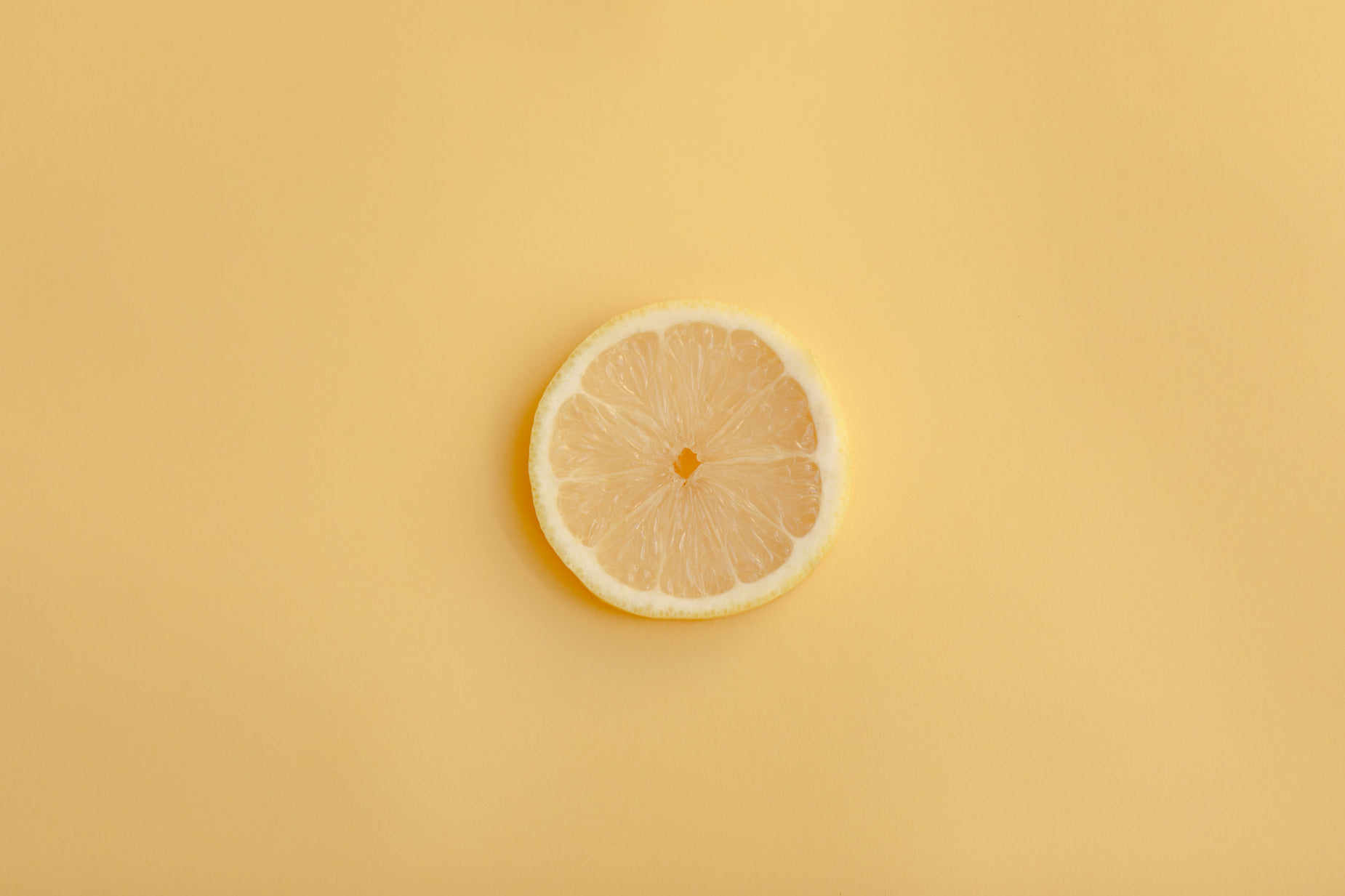 the lemon on the orange is half empty