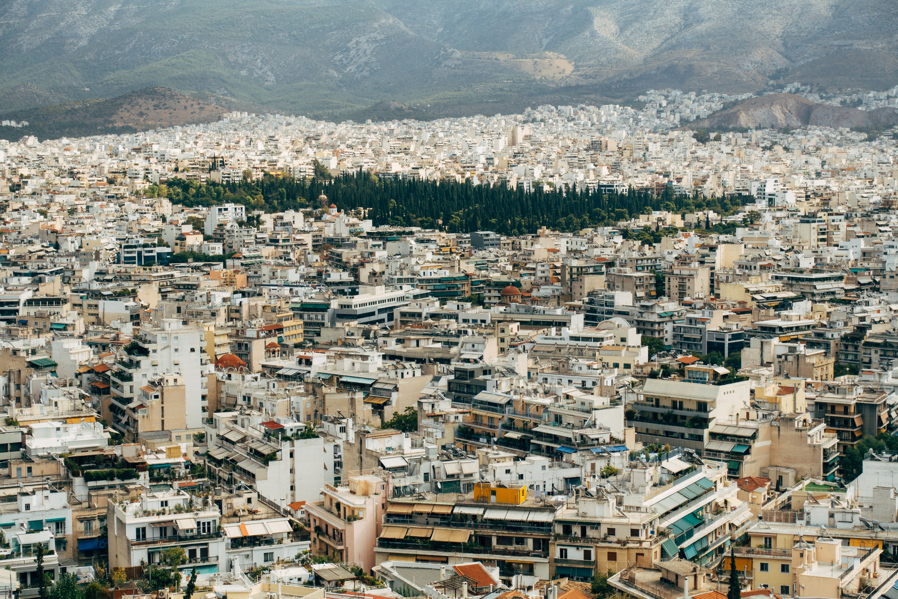 a view of the city, including mountains and hills in the distance