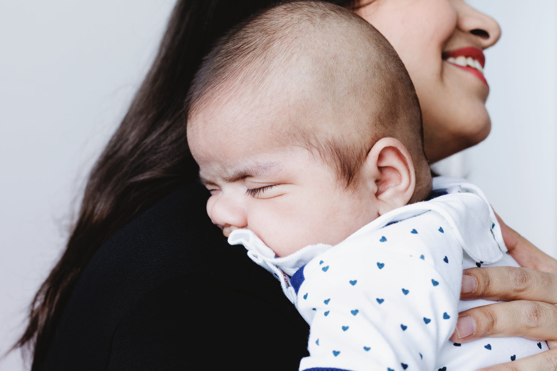 a woman holding her face to a baby