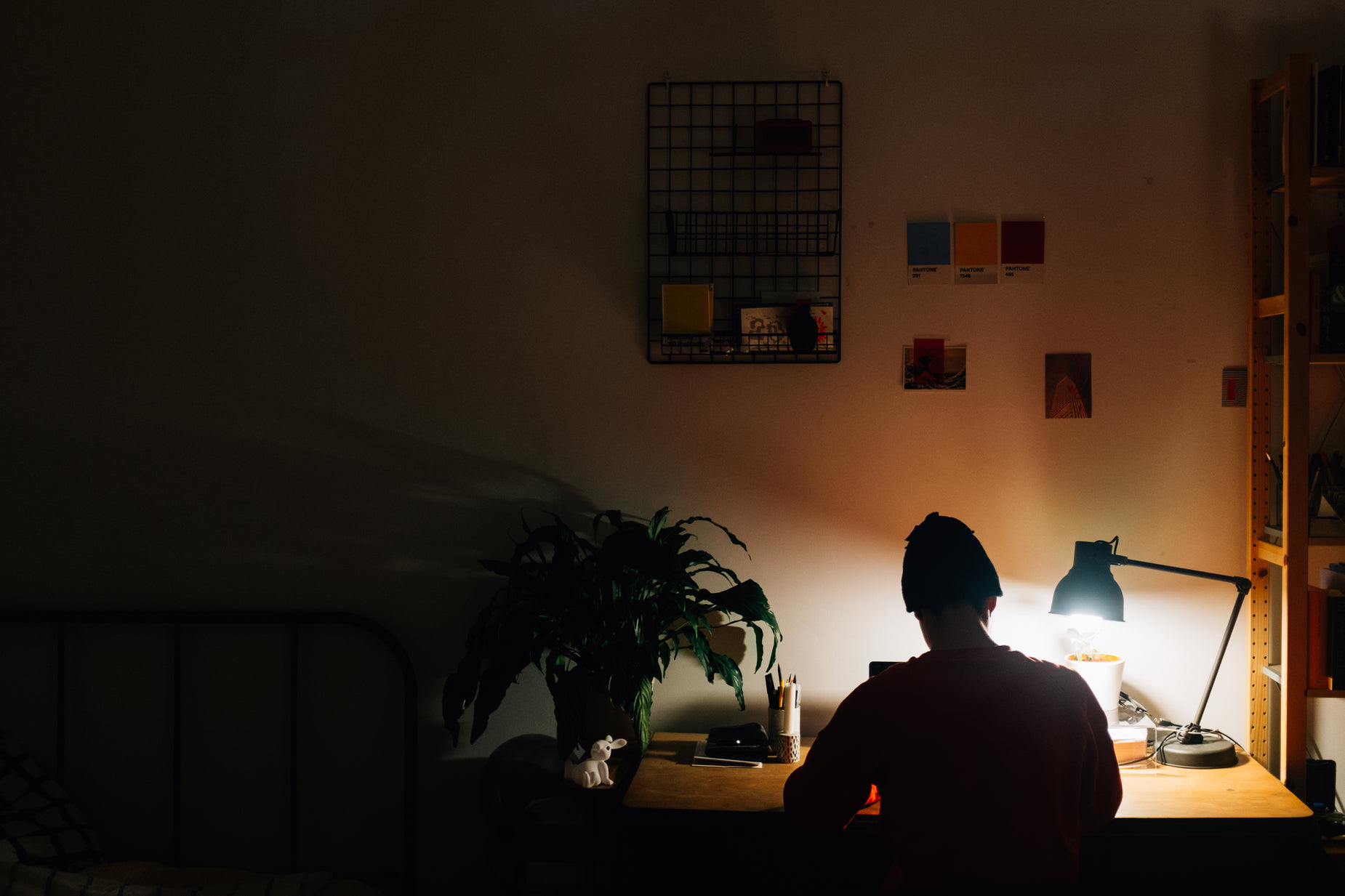 the person is sitting at a desk, watching tv