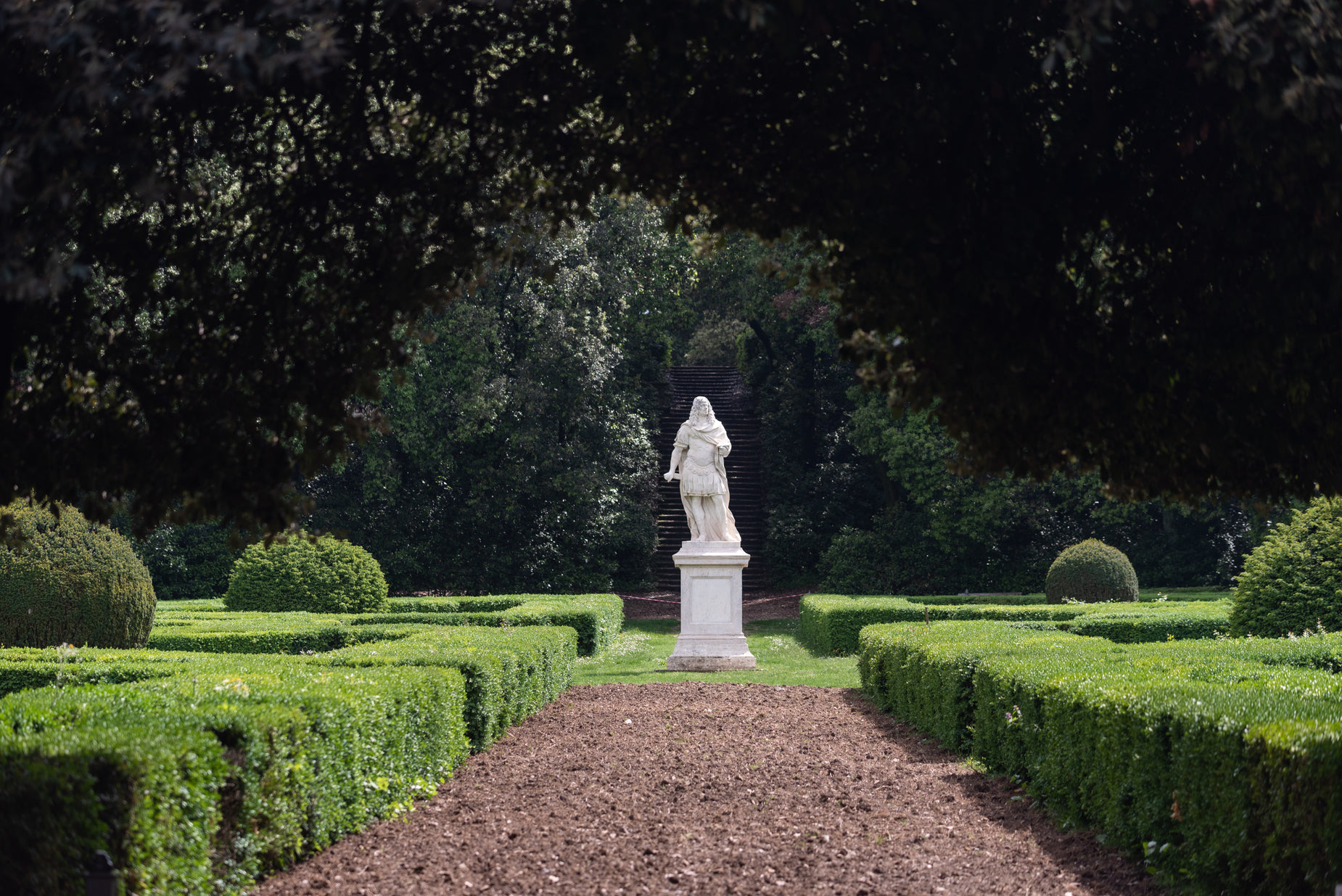 there is a white statue in the middle of the park