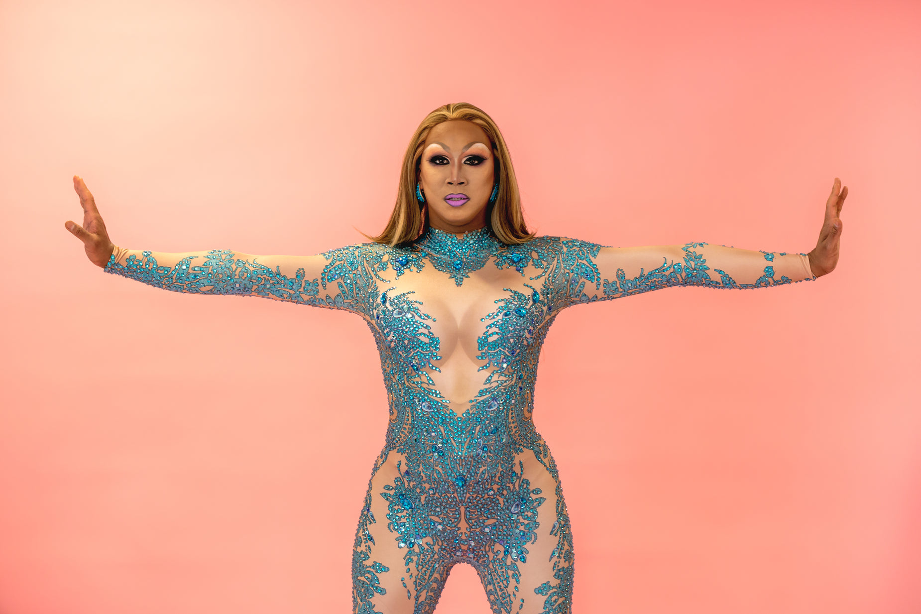 a woman in a bodysuit is posing for a picture