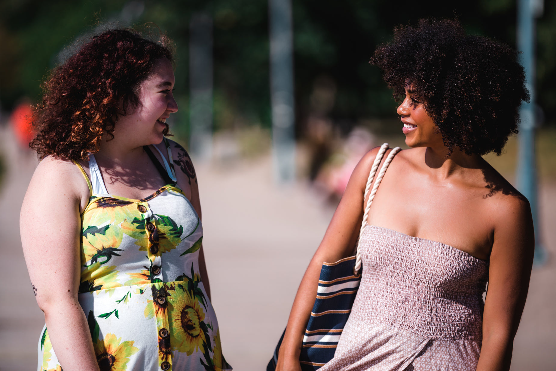 two women are standing near each other smiling