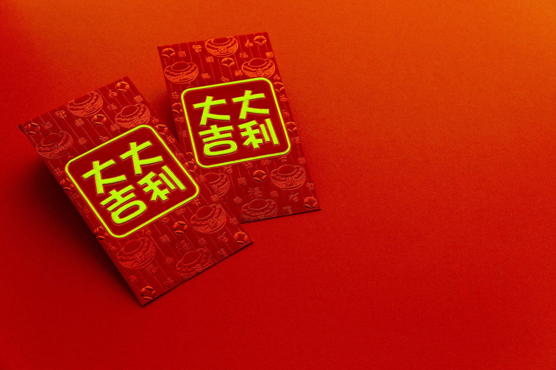 two chinese - language notebooks on a red surface