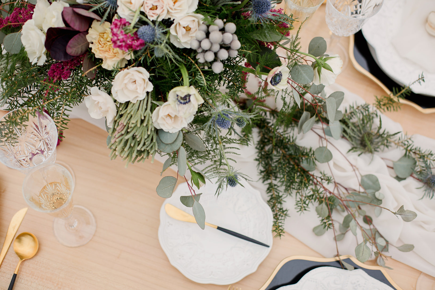 a table set with plates and flowers that are on the table