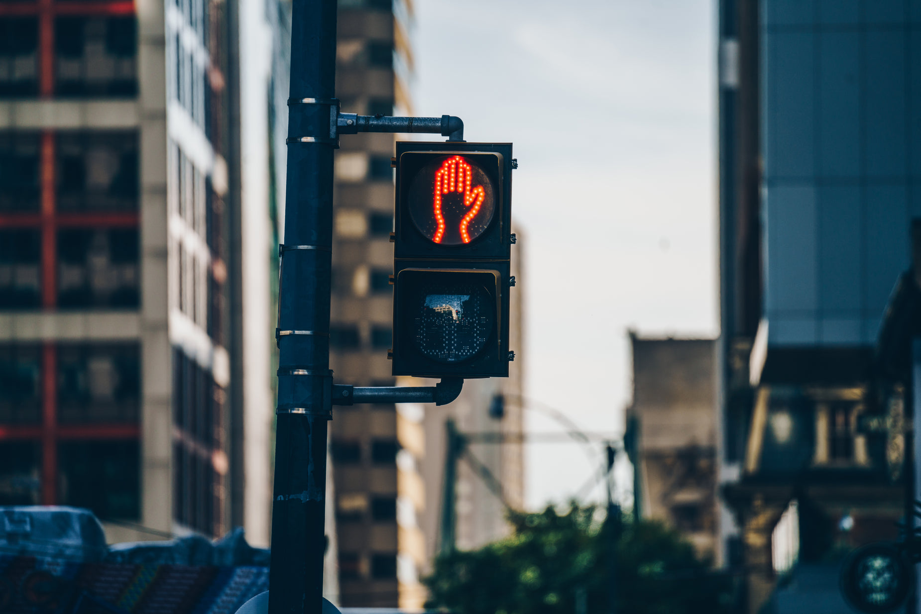 a traffic light displaying red on a busy city street