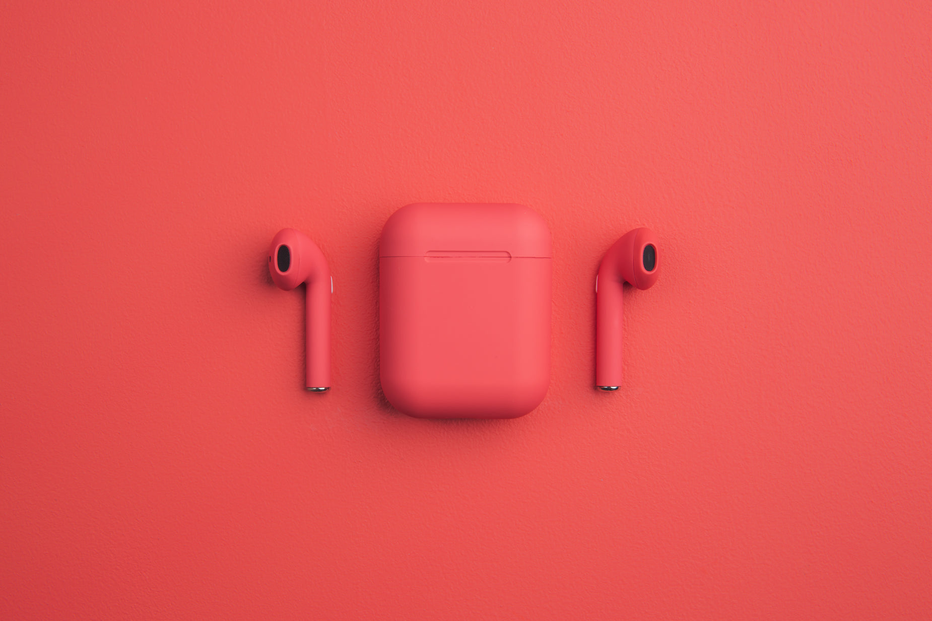 a pair of pink airpods resting next to each other