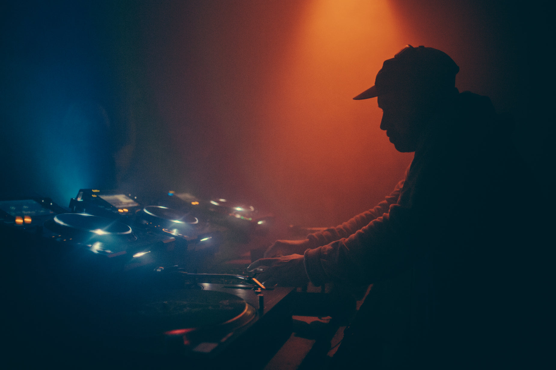 man in front of light and sound equipment at party