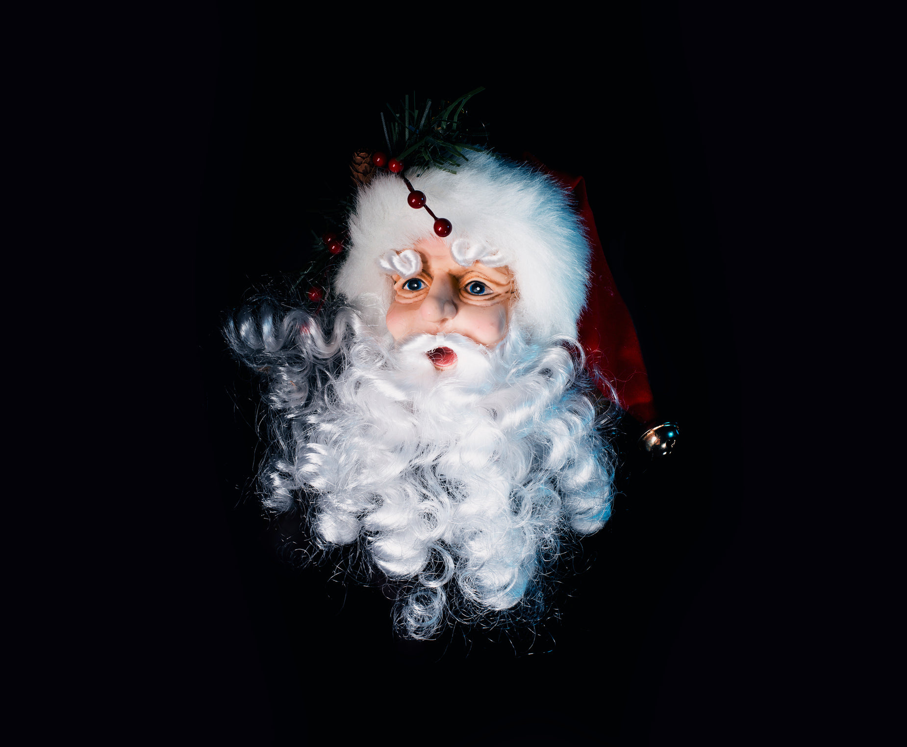 a close up of santa claus, with white hair and a beard