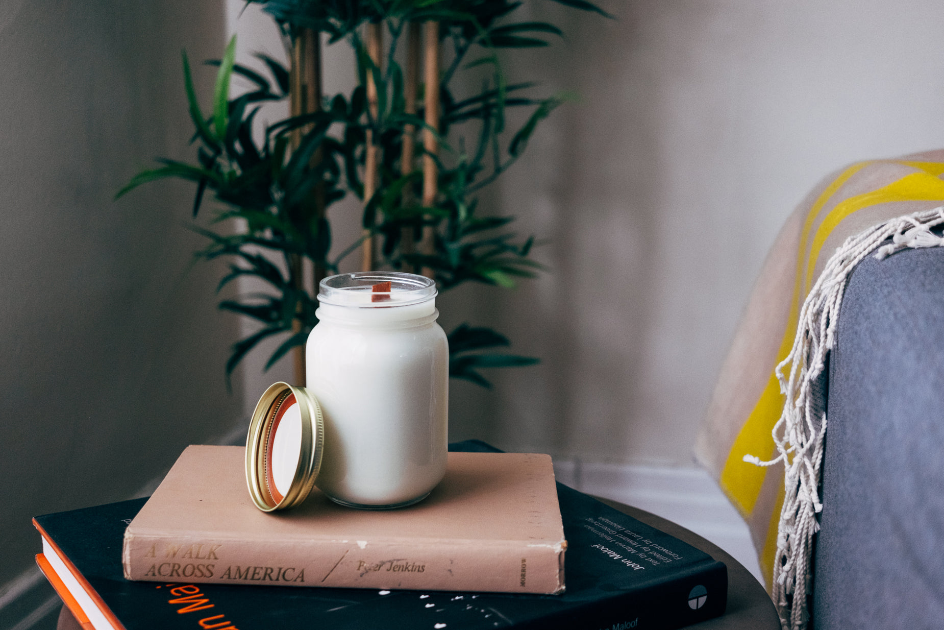 a jar with a candle and a stack of books