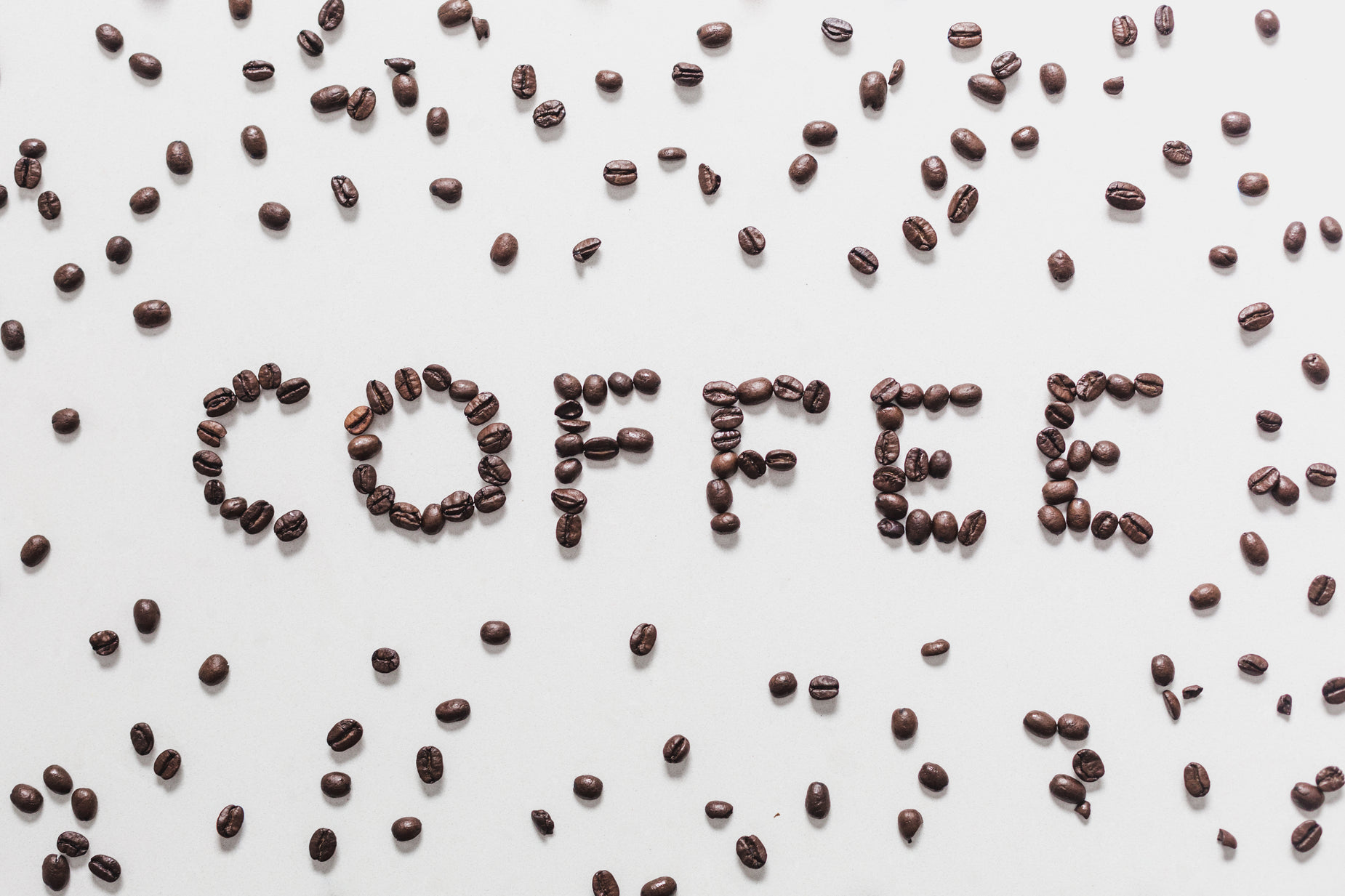 a po of coffee beans with a message written in the center