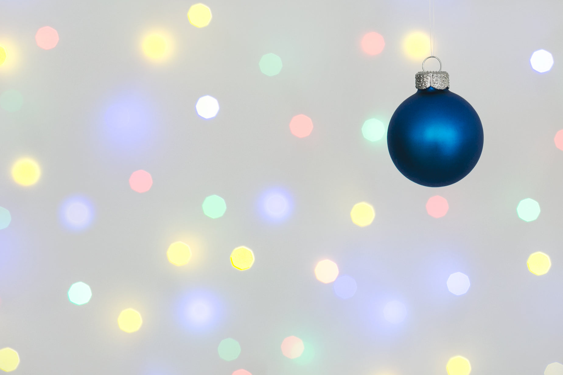 a blue ornament hanging from a string on top of some lights