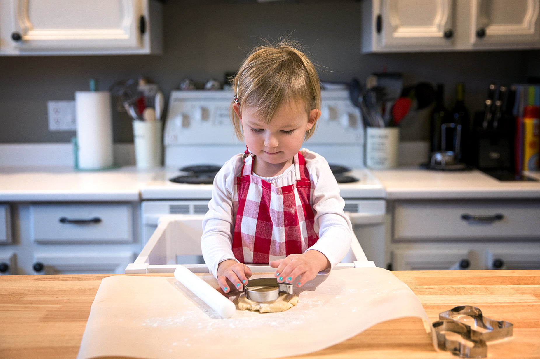 a young child putting food onto a homemade cookie