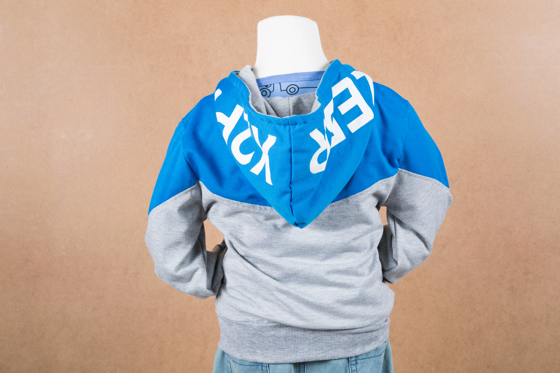 a male mannequin's hoodie is displayed