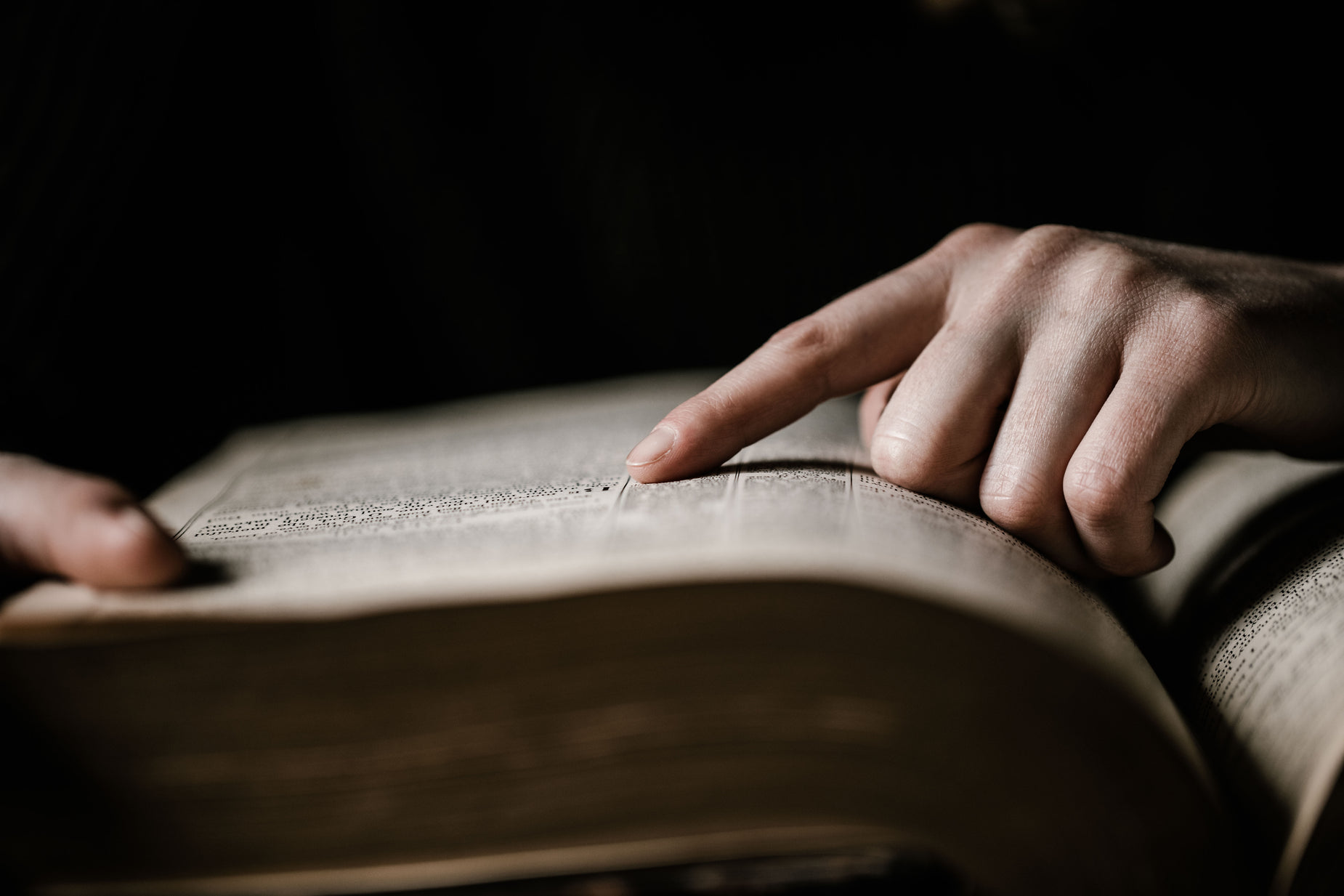 a close up view of a person's hands holding a book