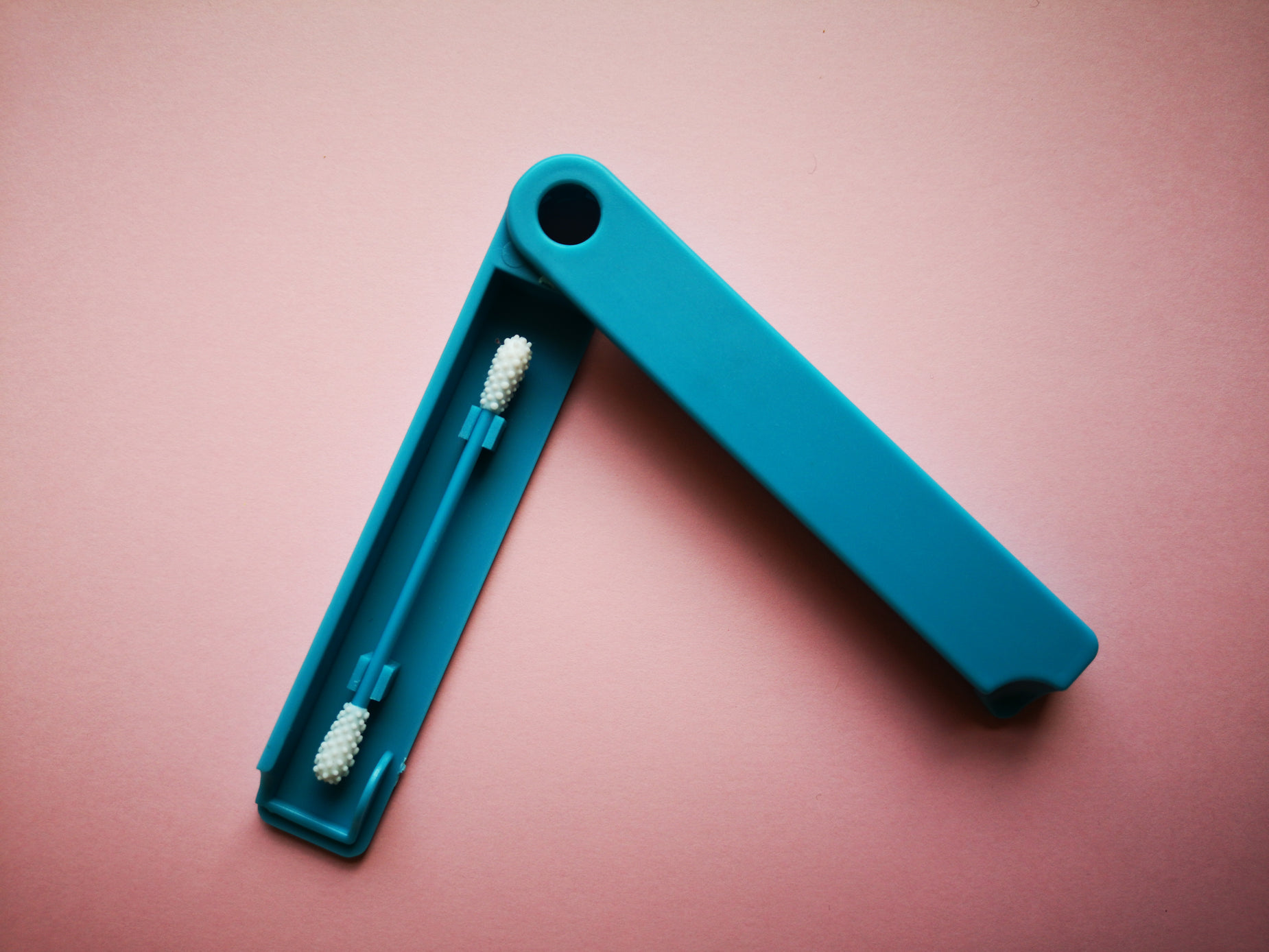 an empty toothbrush with two small toothbrush heads in it