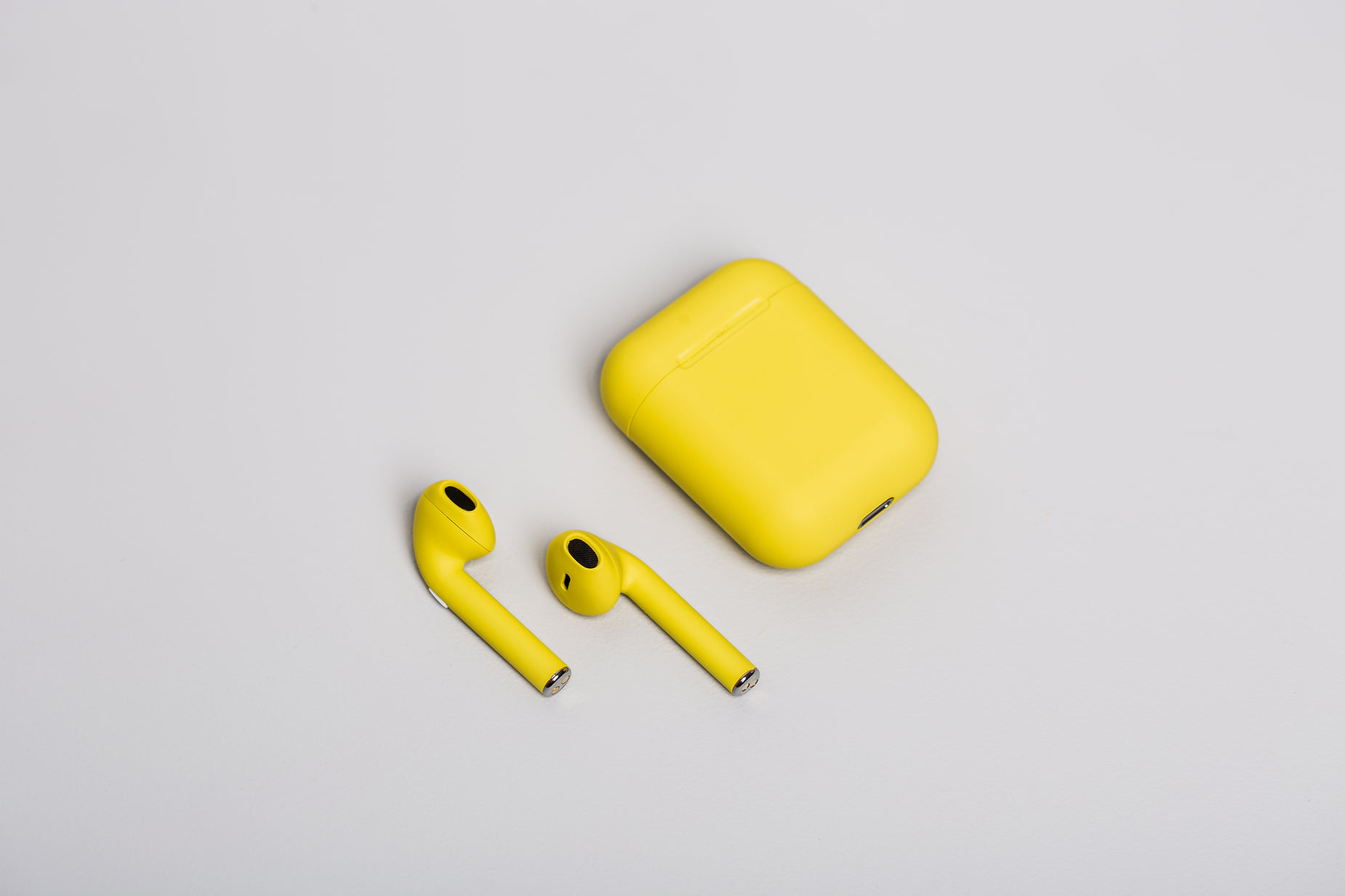 a yellow earpiece is set next to a case