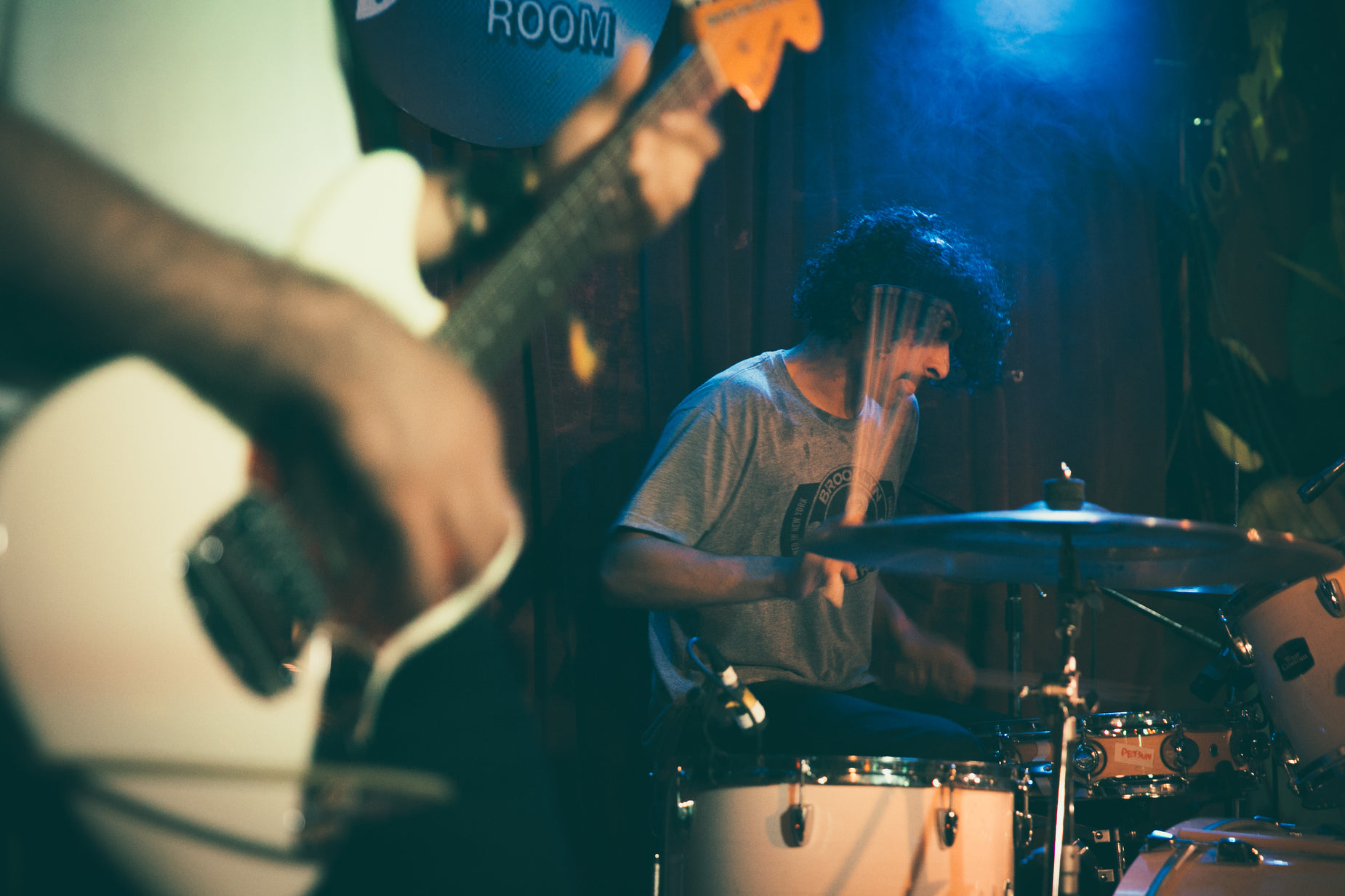 a man playing a guitar while a band plays