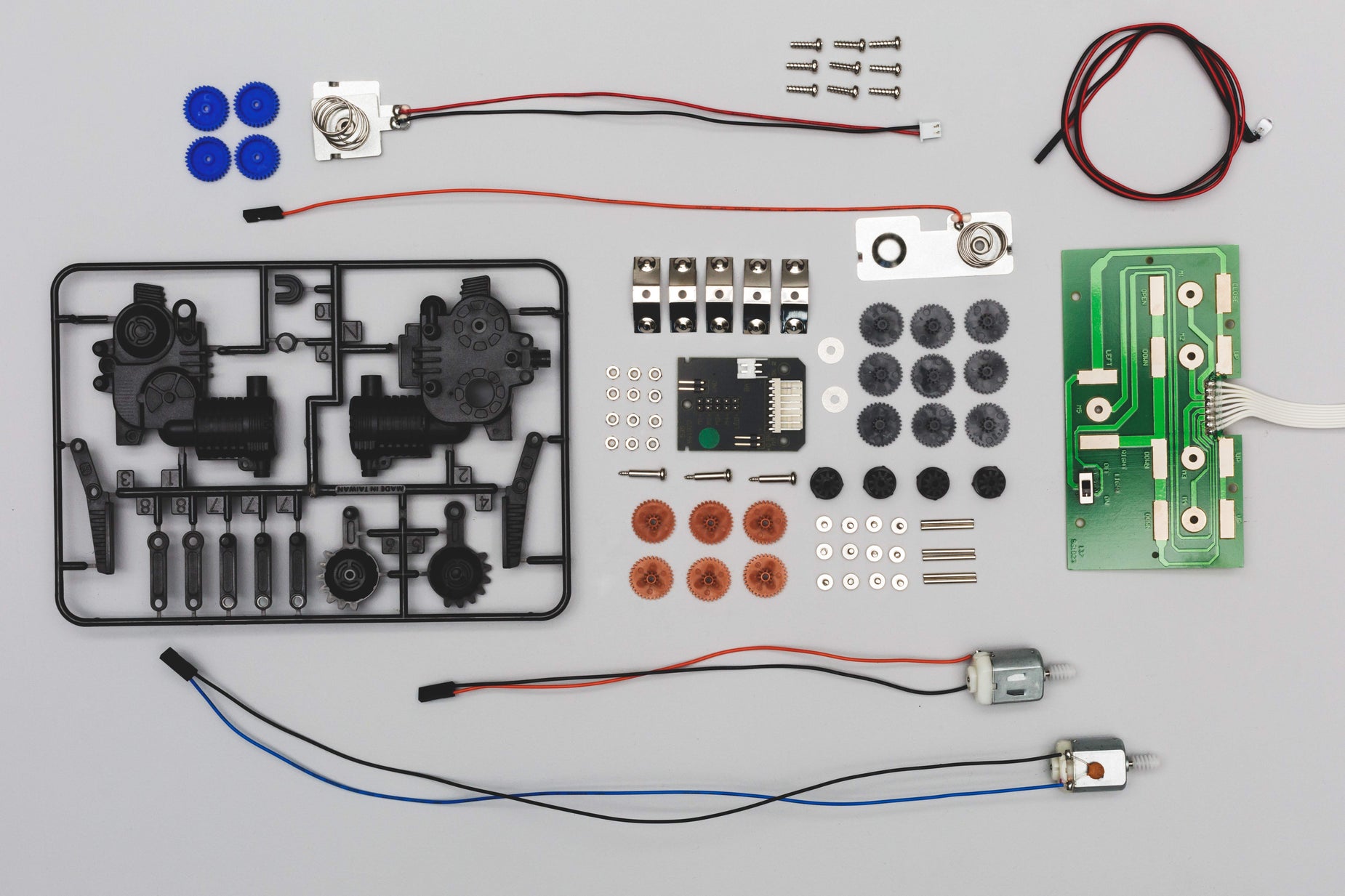 parts of electronic machine on table with wires