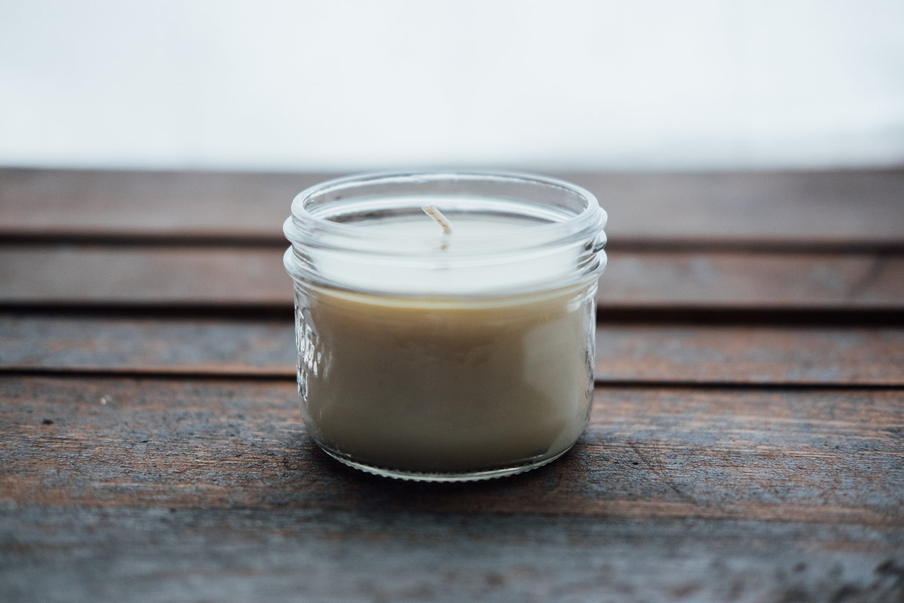 a glass cup sitting on top of a wooden table