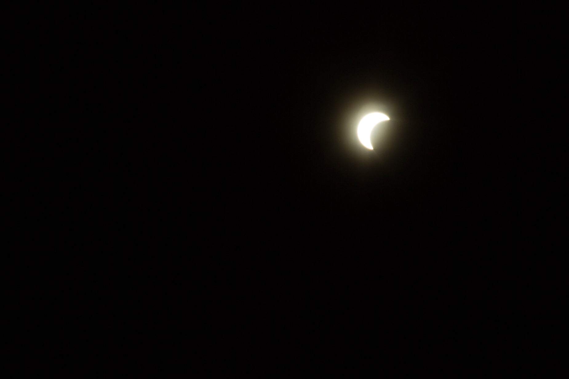 the moon seen in a dark sky at dusk