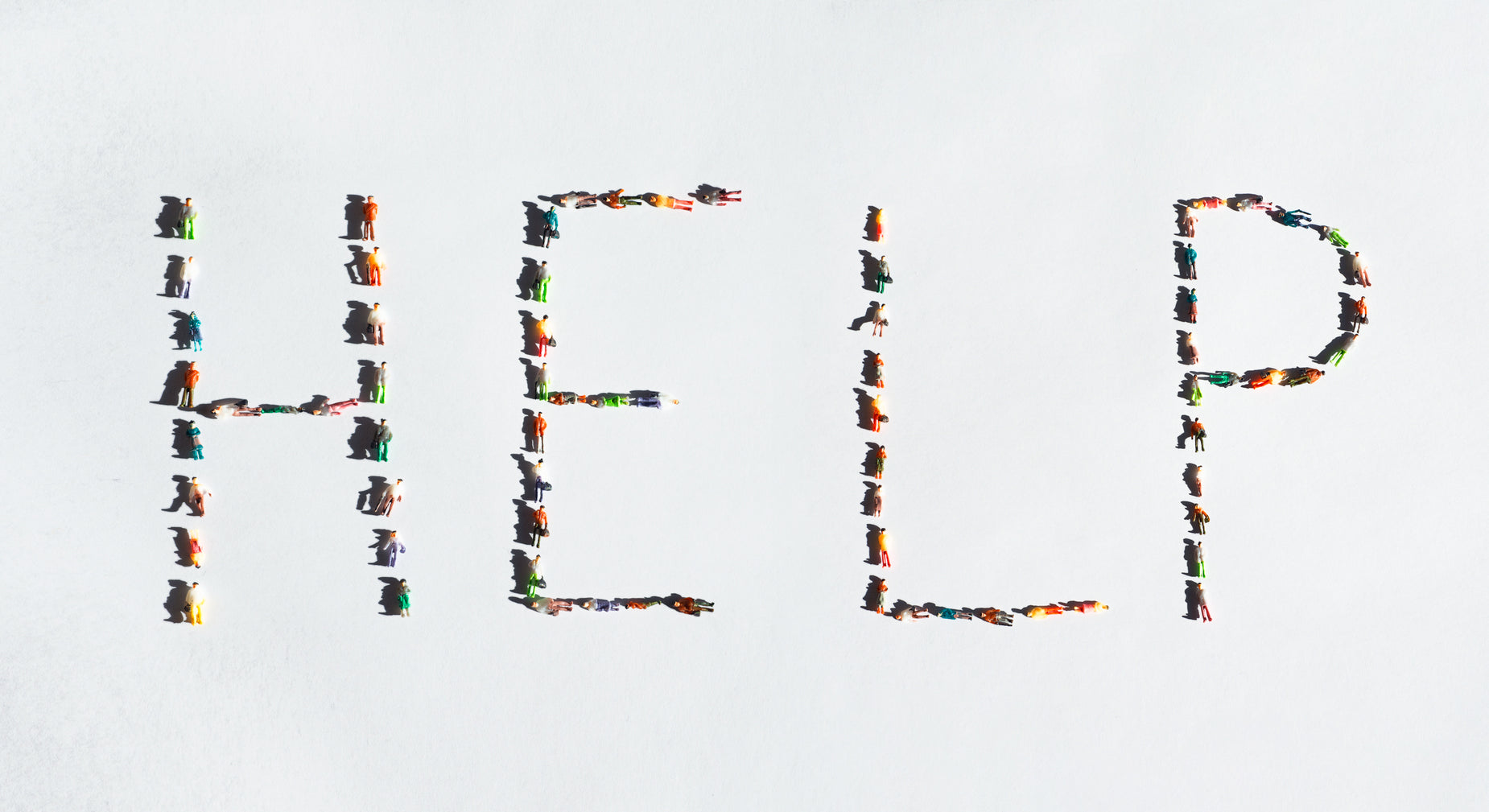 the word help spelled out in an array of different colored people