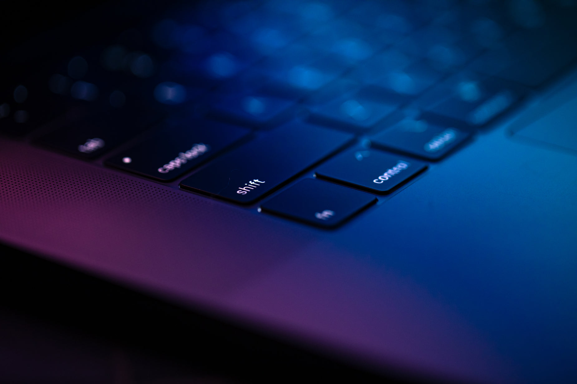 the keyboard of a laptop with illuminated keys