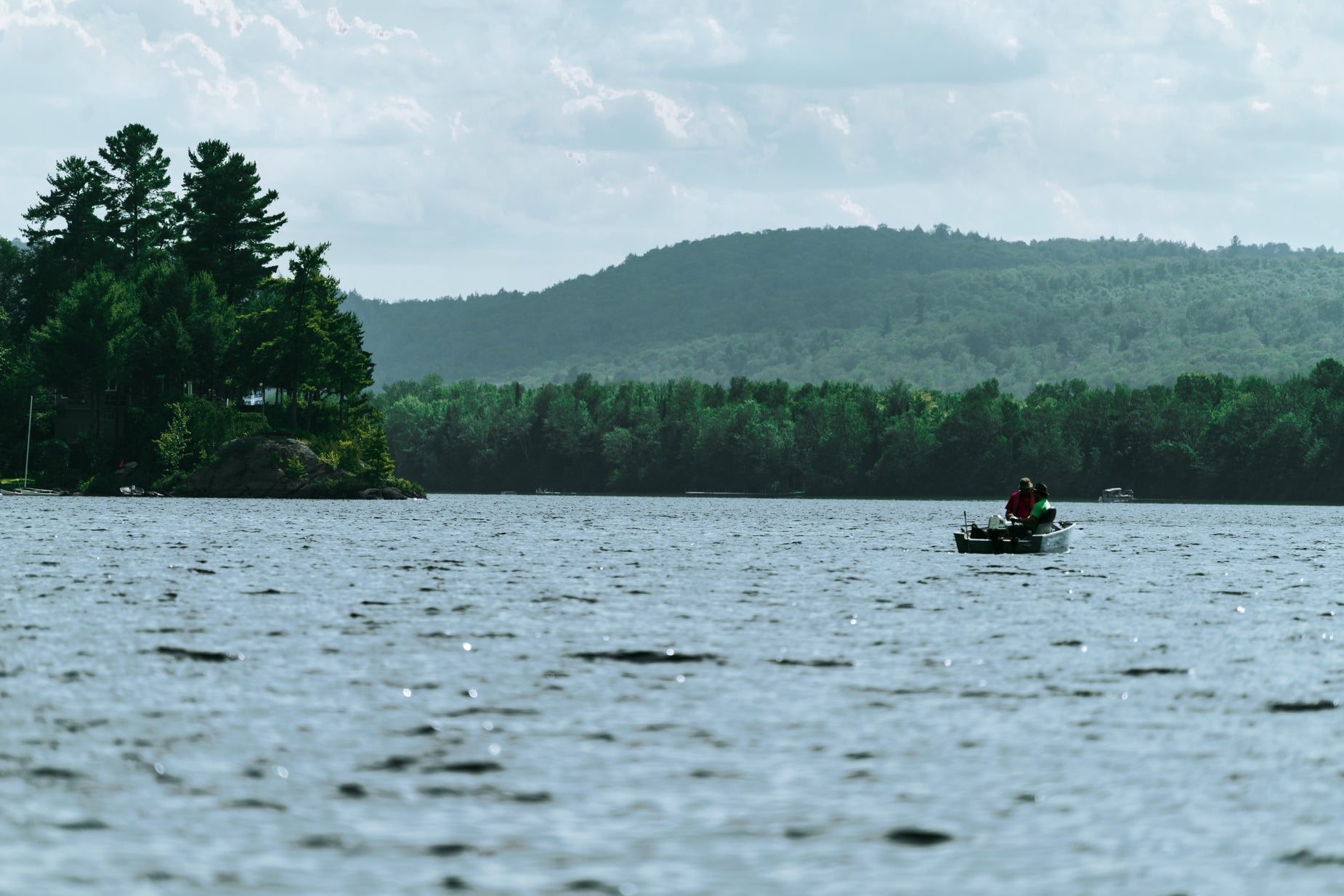 a man on a small boat floating down a lake