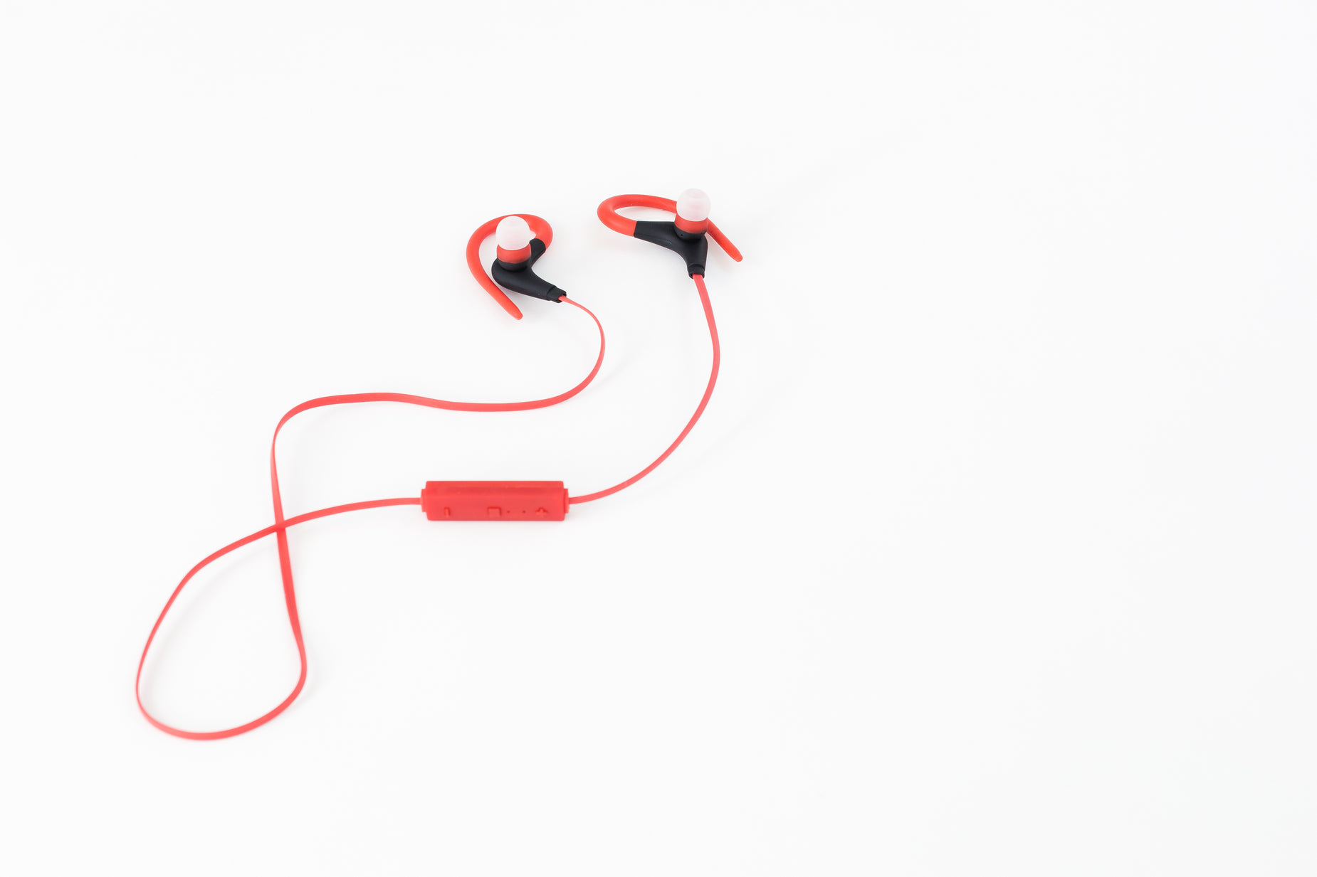 a pair of red ear buds on a white background