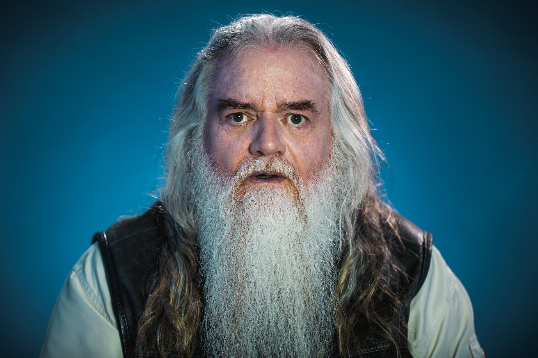 a portrait of an older man with a long beard
