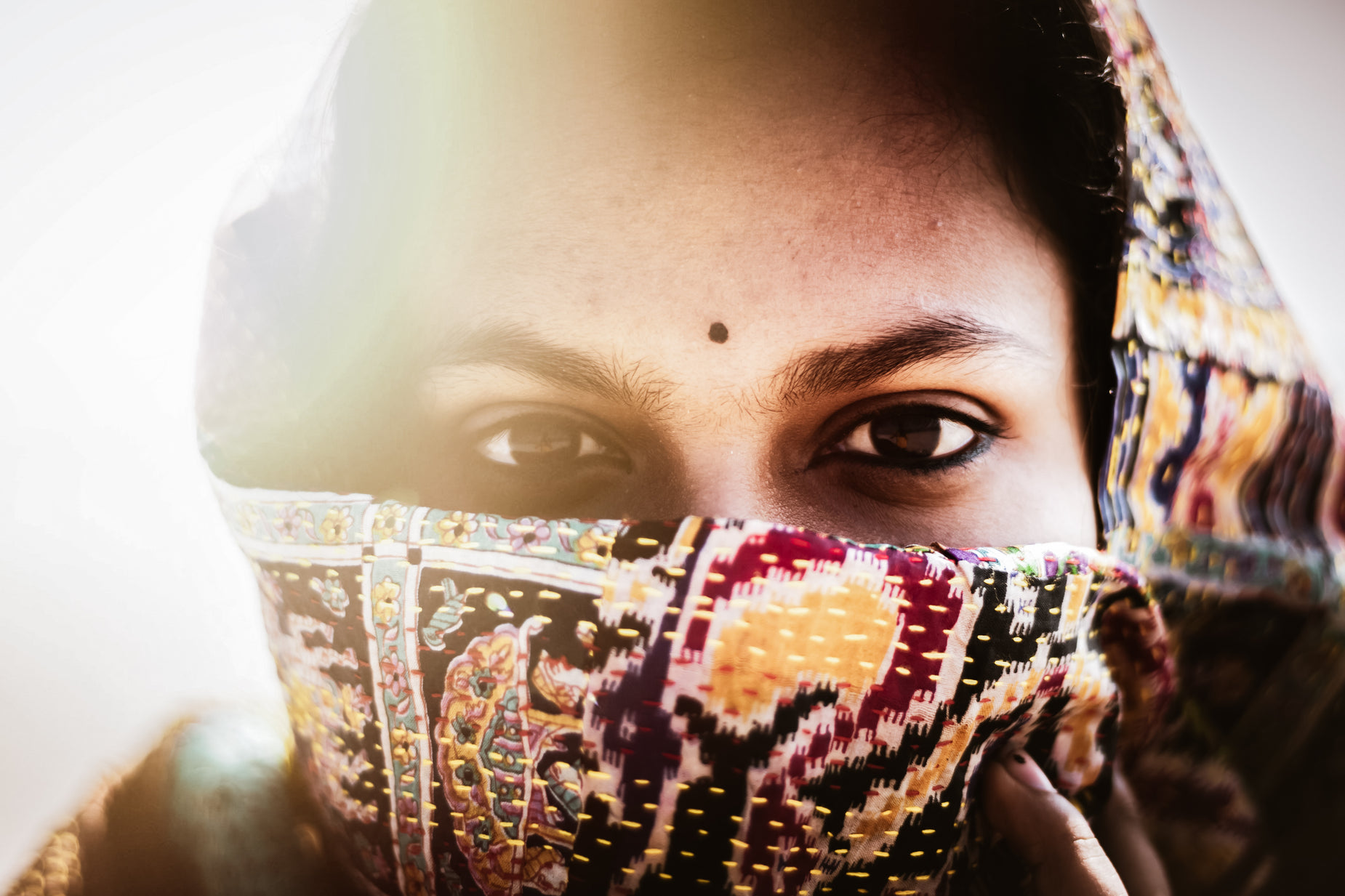 a woman is covering her face with her hand