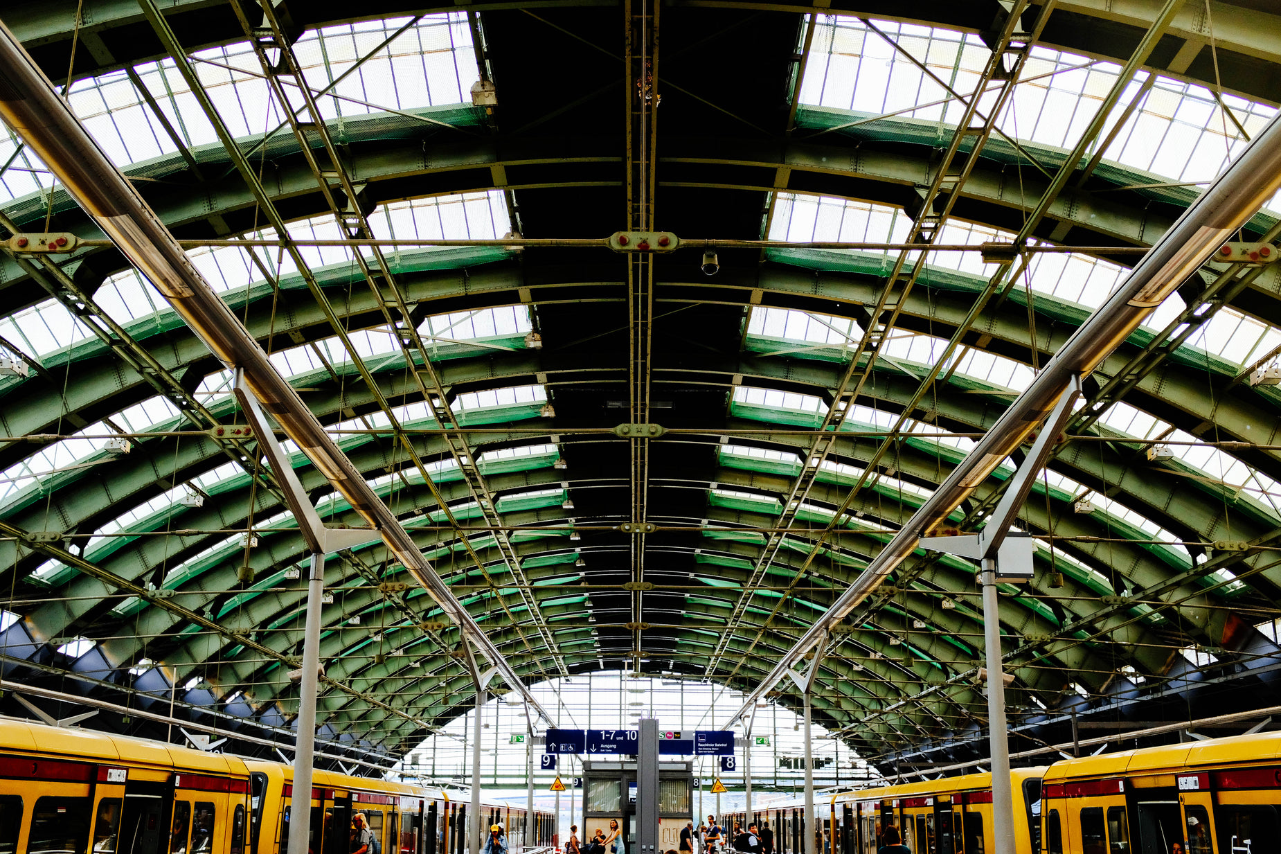 a very big pretty looking train station with some trains on it