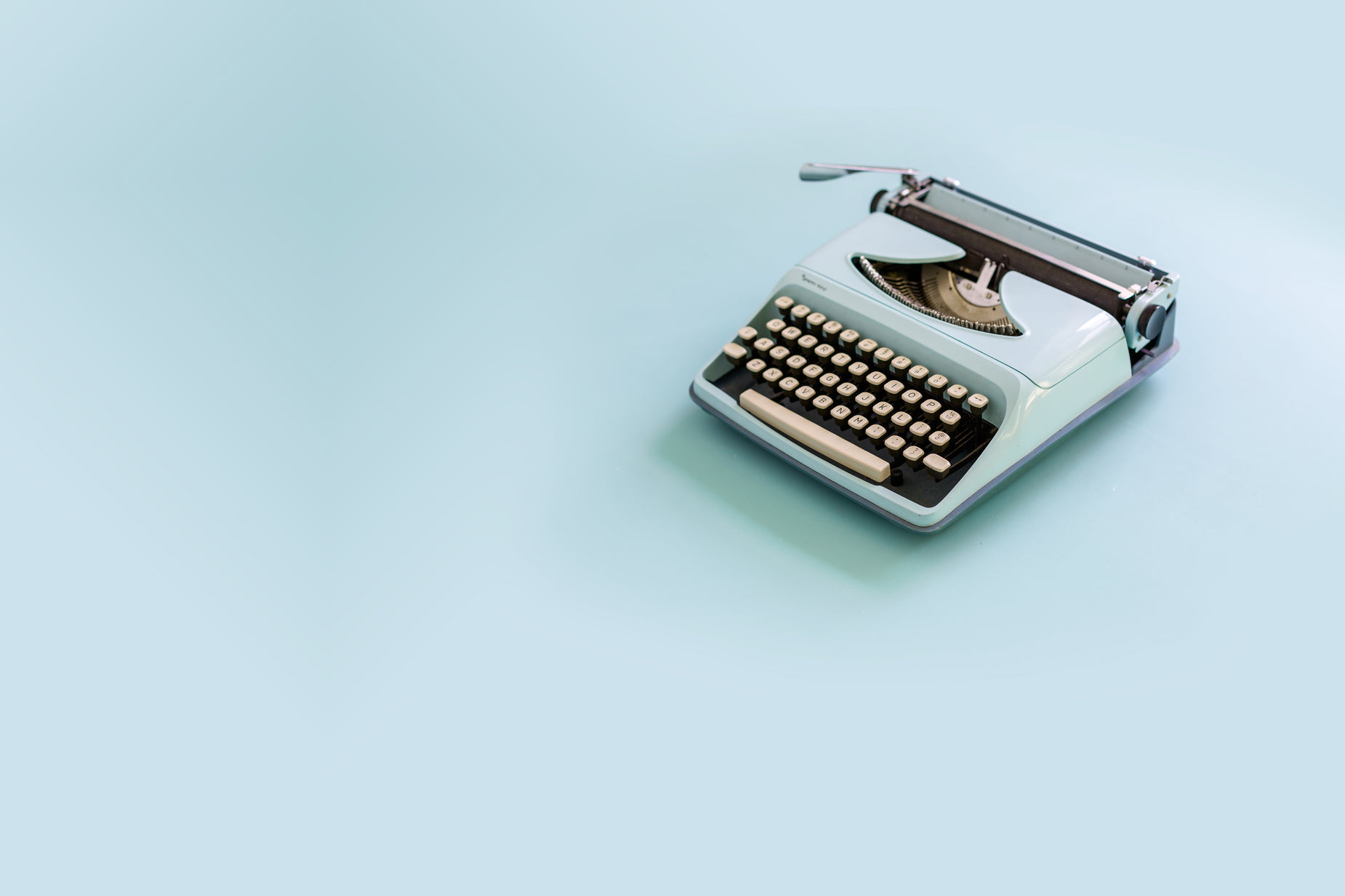 an old typewriter on a blue background