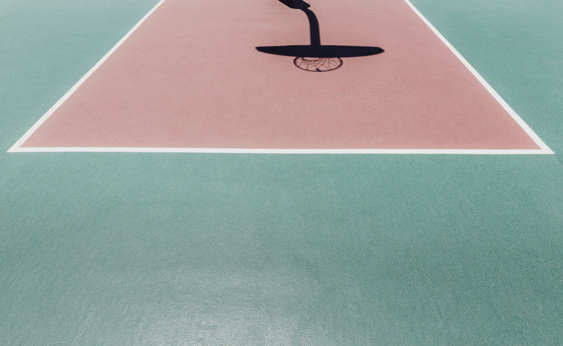 the shadow of a tennis player is displayed on the court