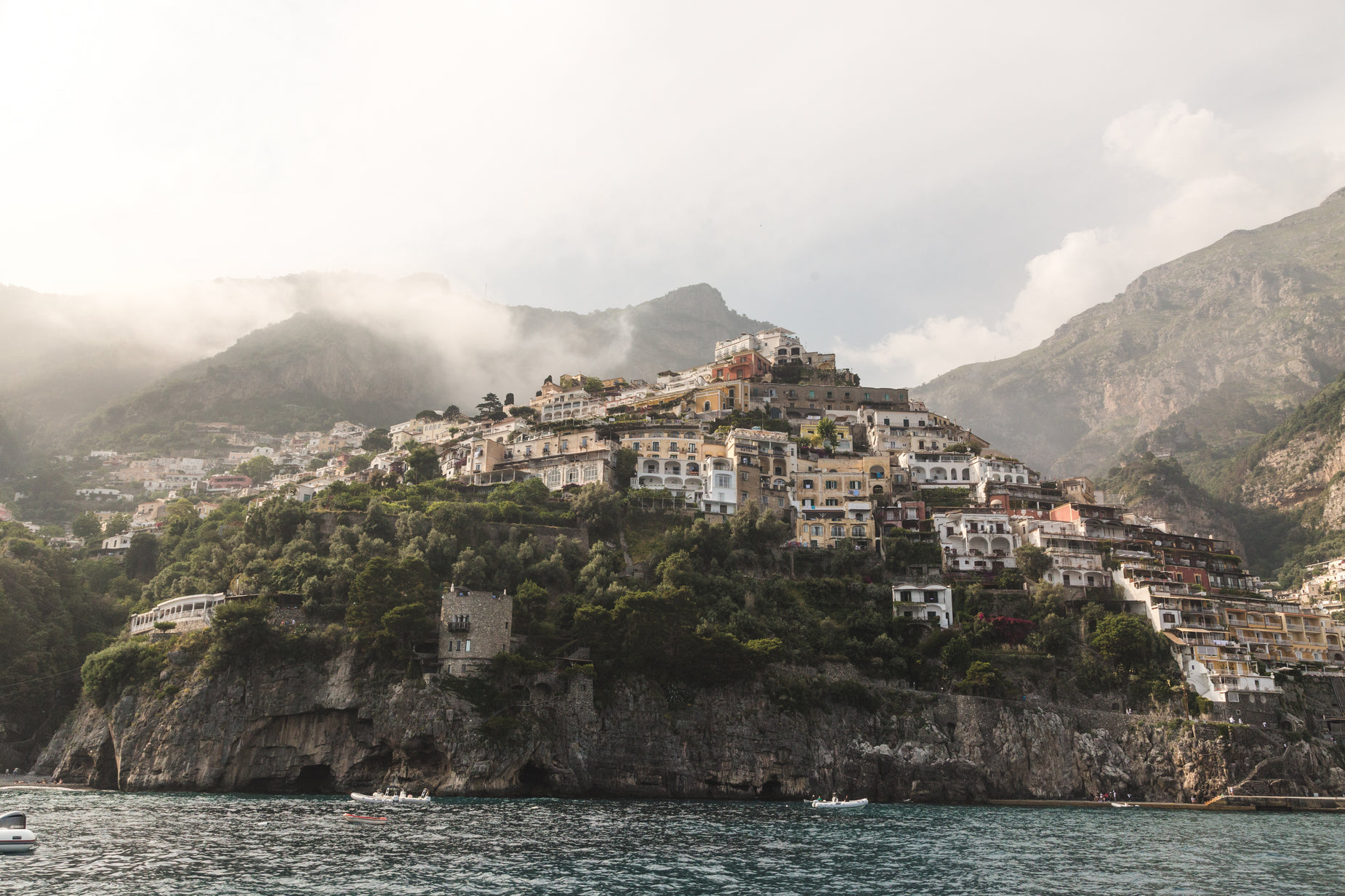 a village on the top of a hill near water