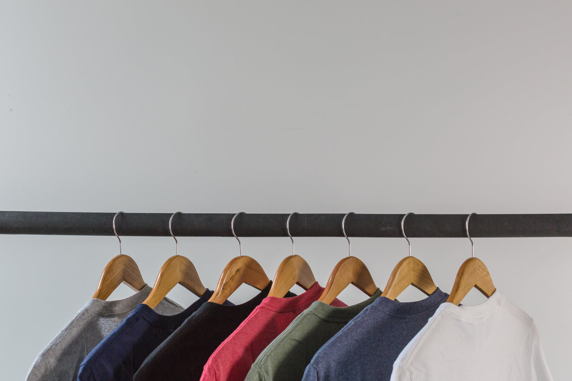 a row of t - shirts hanging on a rail