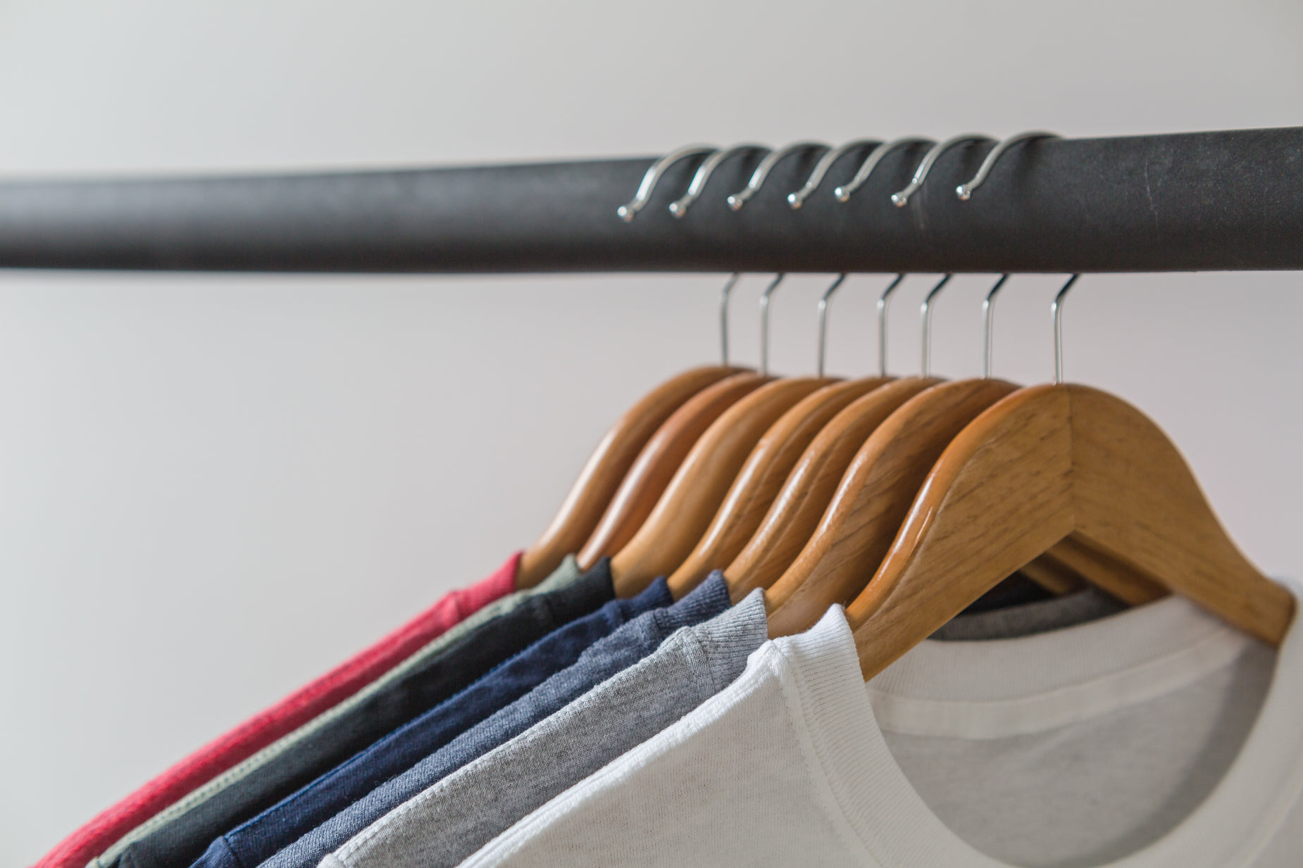 six shirts on hangers on the clothes rail