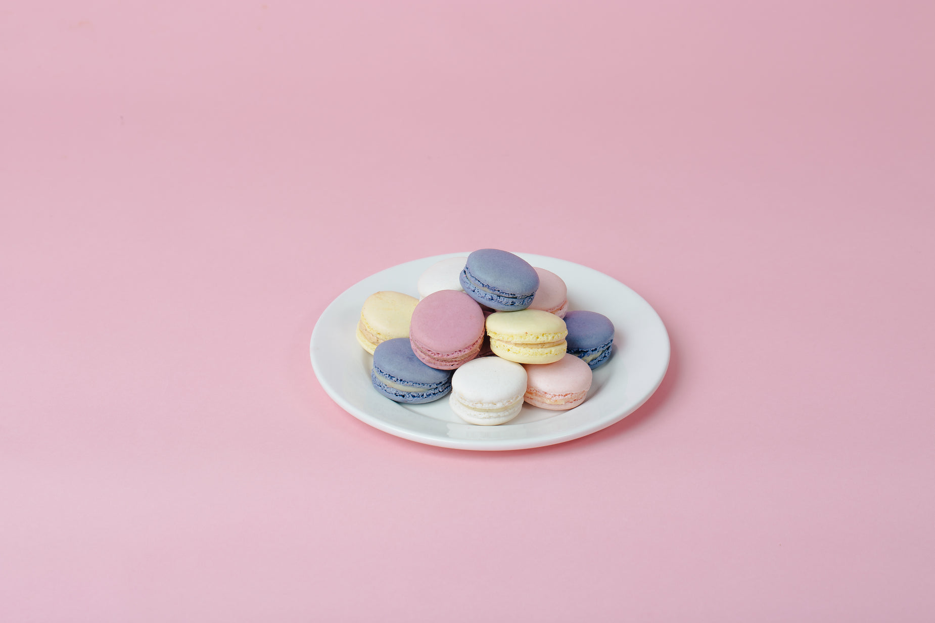 some colorful, round, and plain looking cakes on a plate