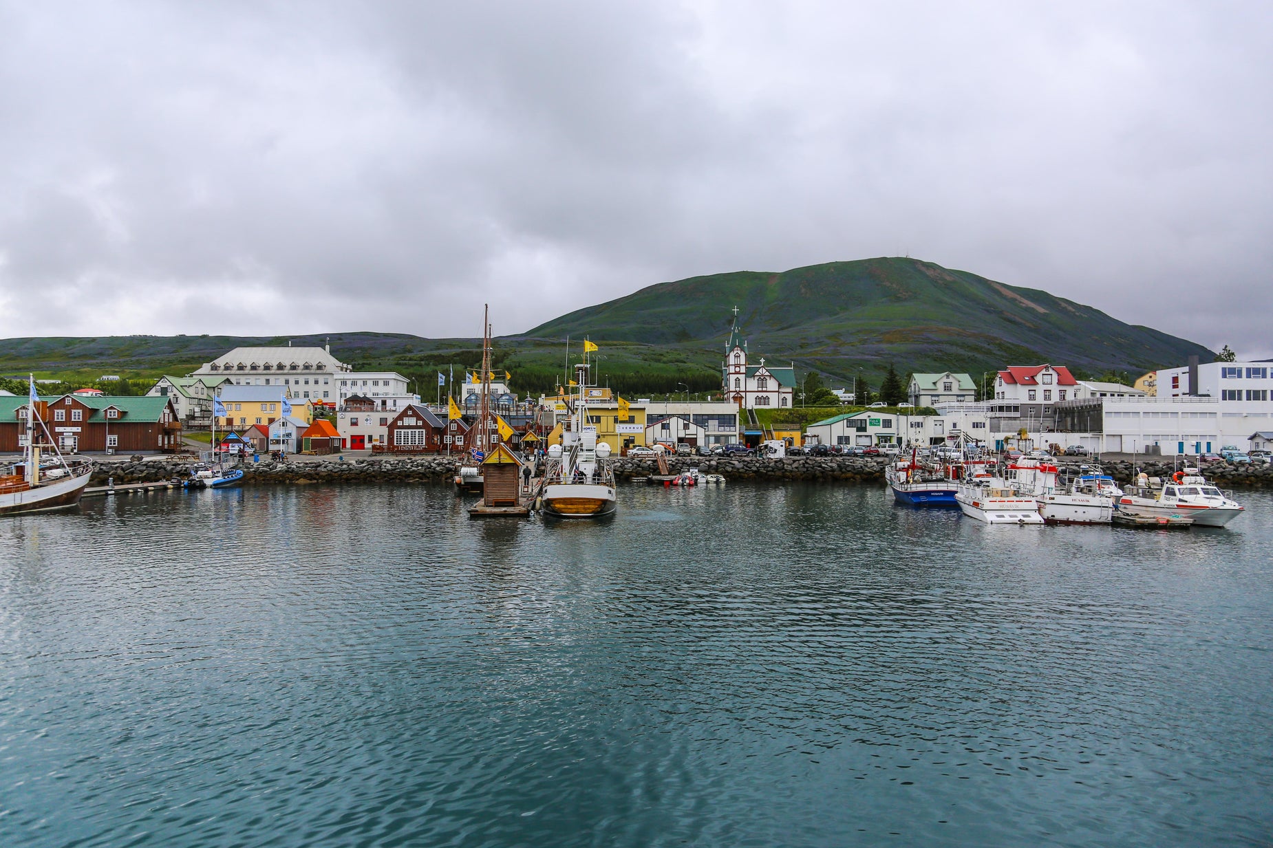 a row of docked boats next to a town